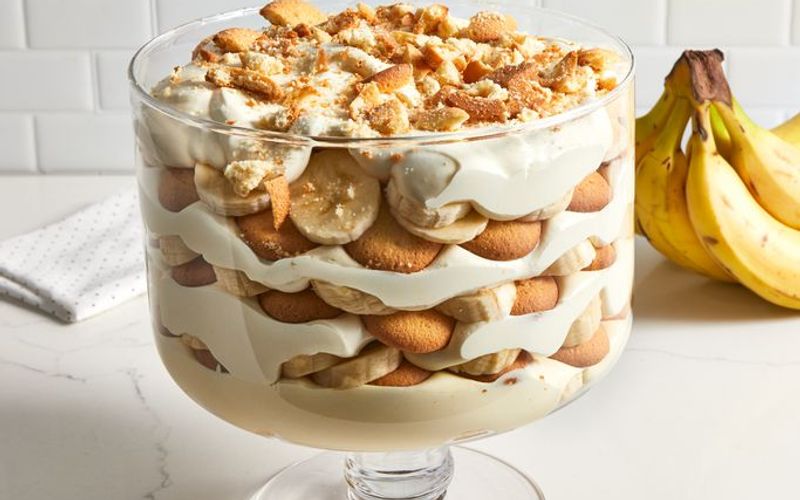 Classic Southern banana pudding recipe showing layered cross section with softened Nilla wafers banana slices and vanilla custard filling in a white serving dish