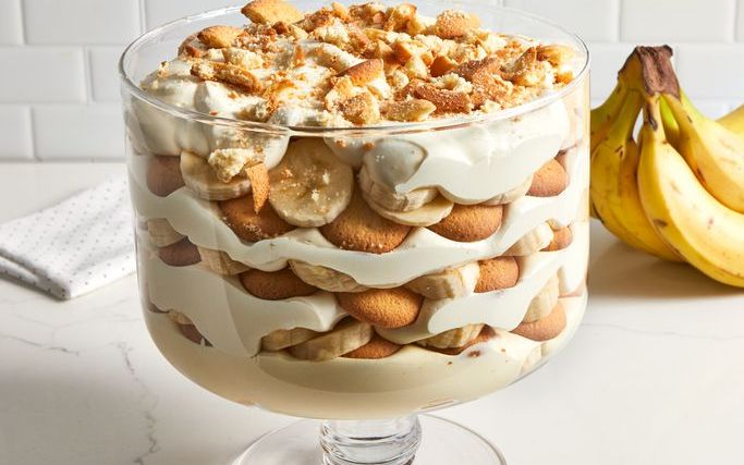 Classic Southern banana pudding recipe showing layered cross section with softened Nilla wafers banana slices and vanilla custard filling in a white serving dish