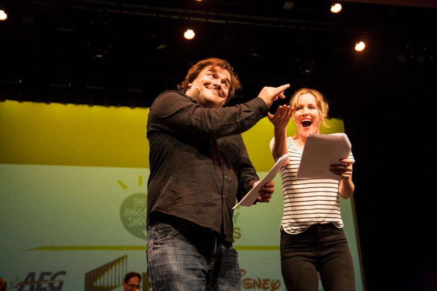 A man and woman perform on stage