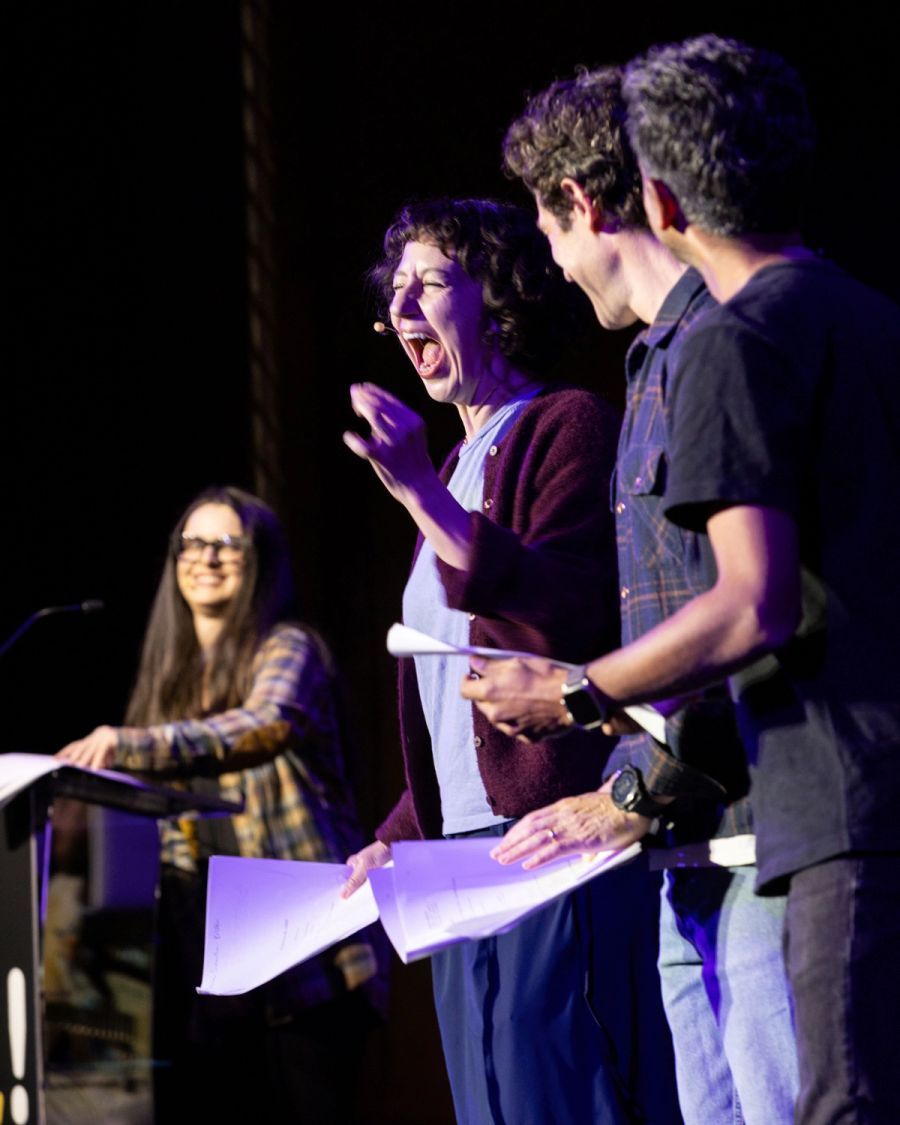 A woman stands on stage, mid-scream