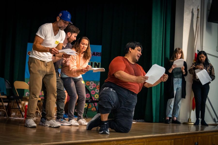 A group of actors perform on stage