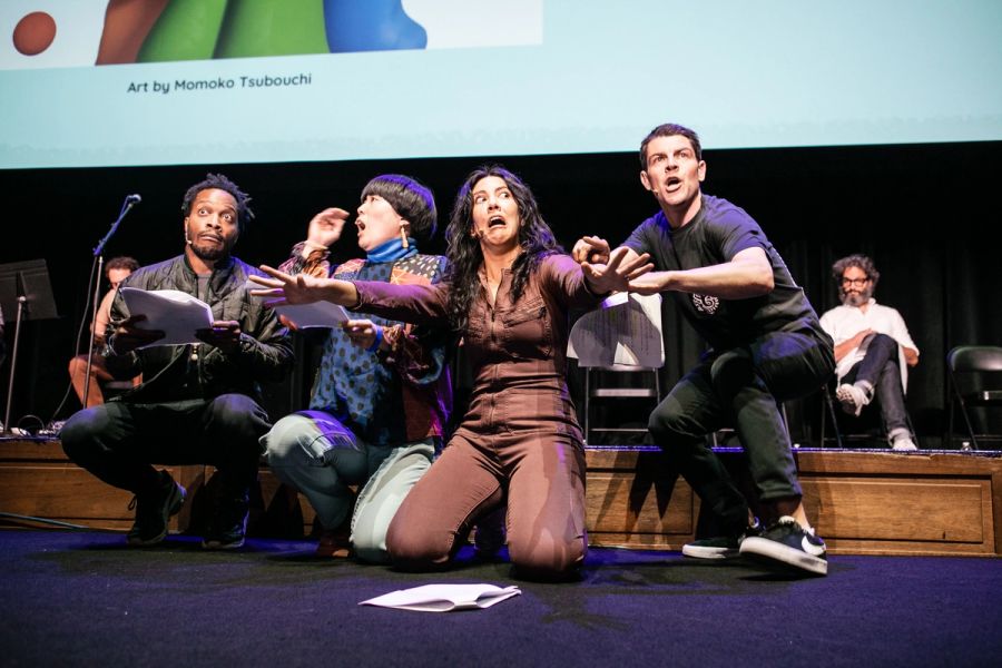 A group of actors perform on stage