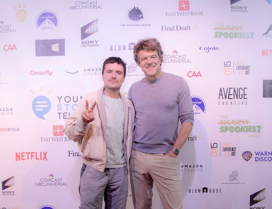 Two men, Josh Hutcherson and Jason Blum, stand on a red carpet, smiling