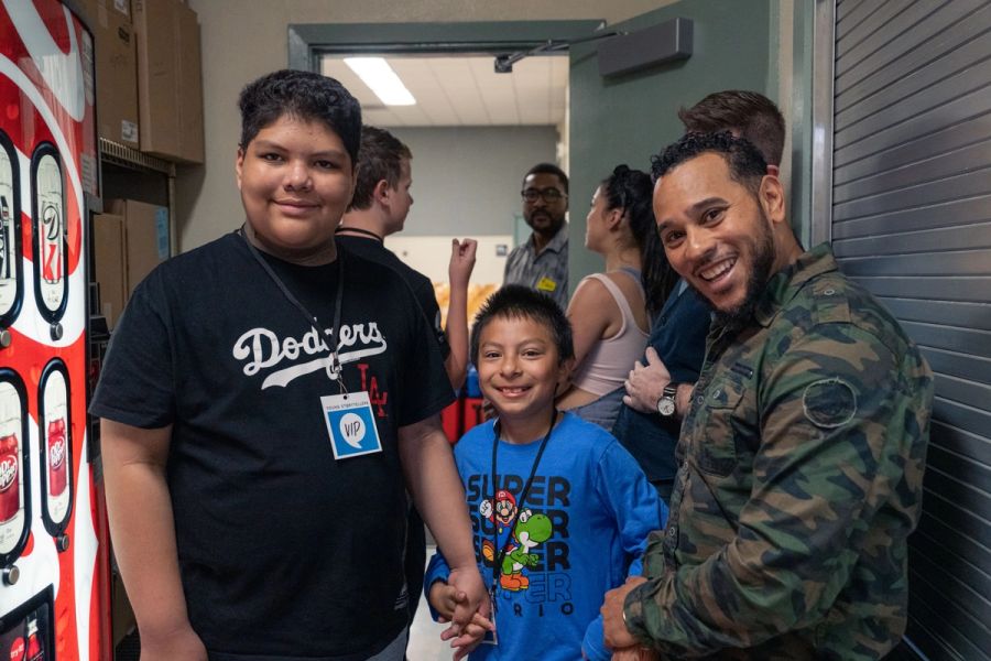 Two students and a mentor smiling for the camera