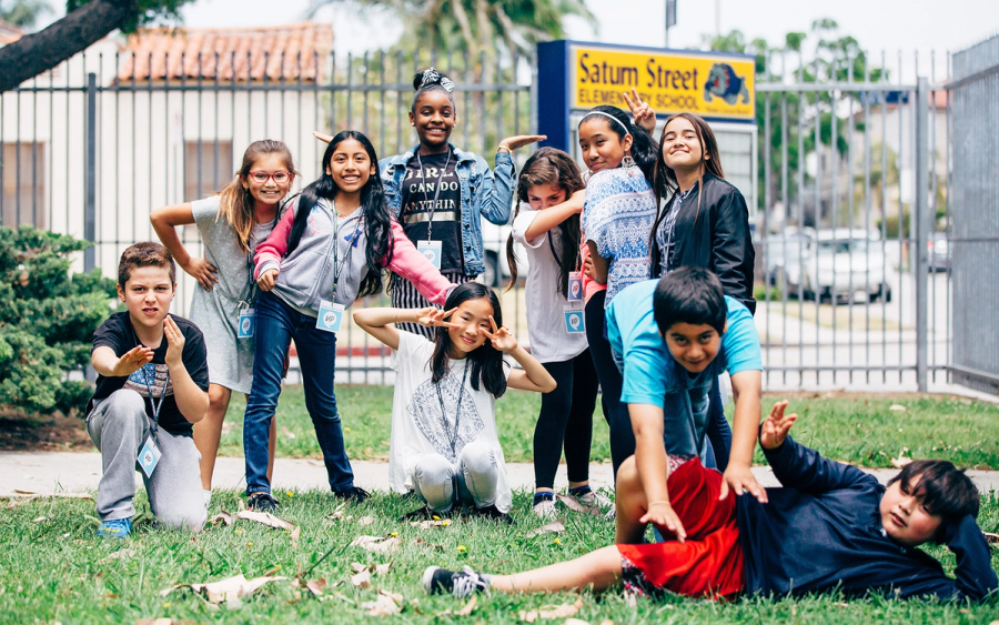Students posing together outside their school