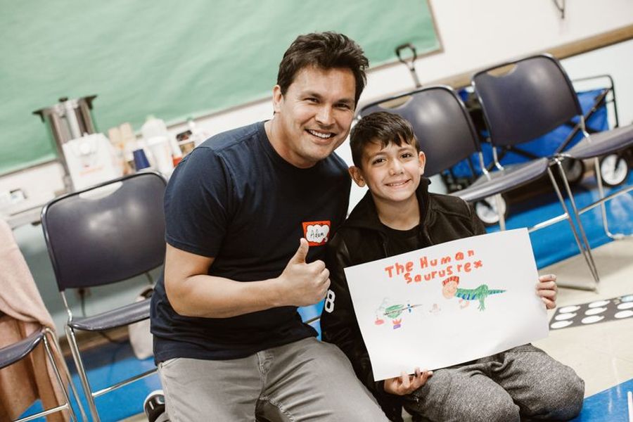 A mentor and a student presenting their story poster
