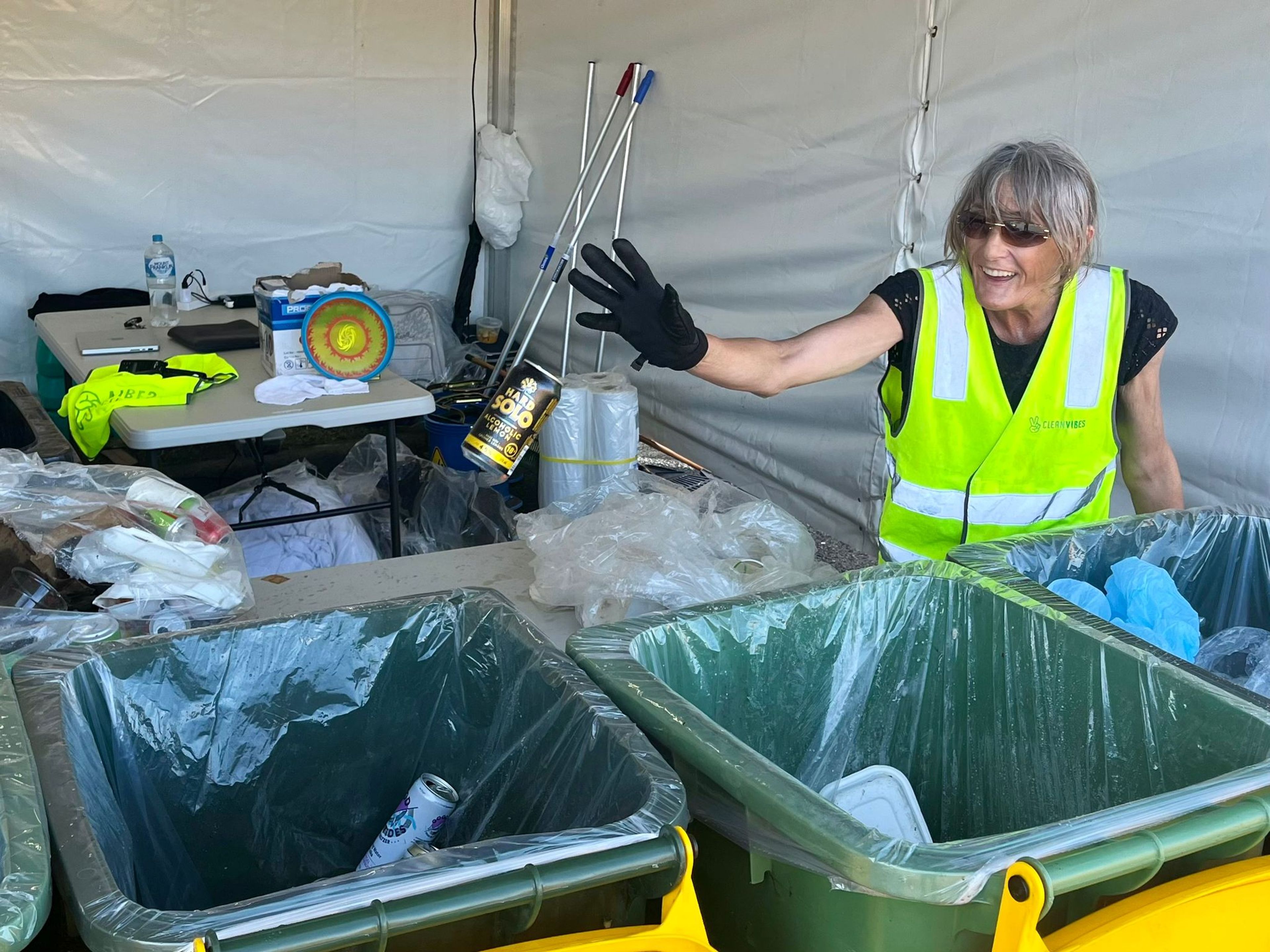 Clean Vibes staff throwing can into a bin