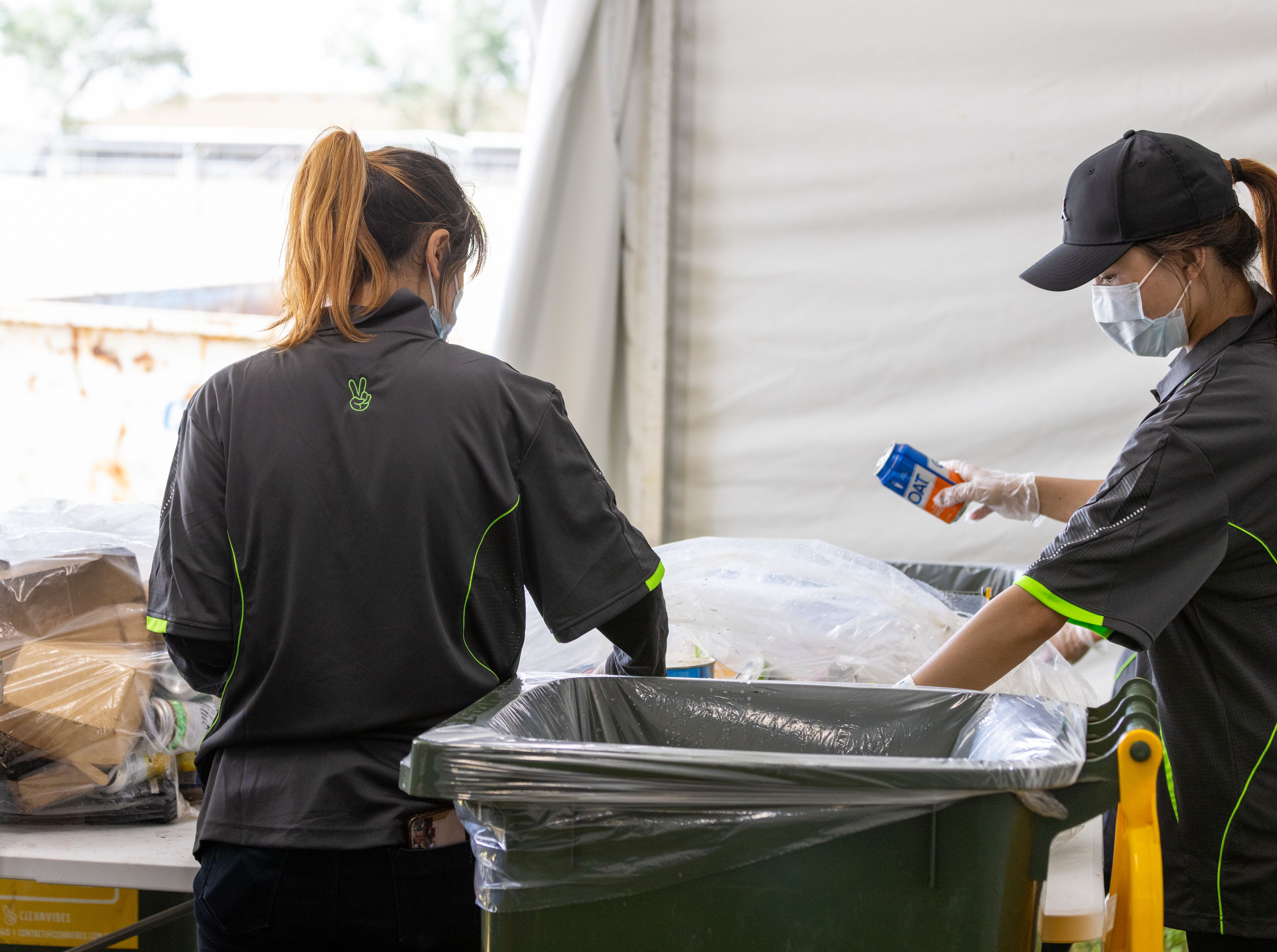 Clean Vibes employees separating recyclable items and general waste items