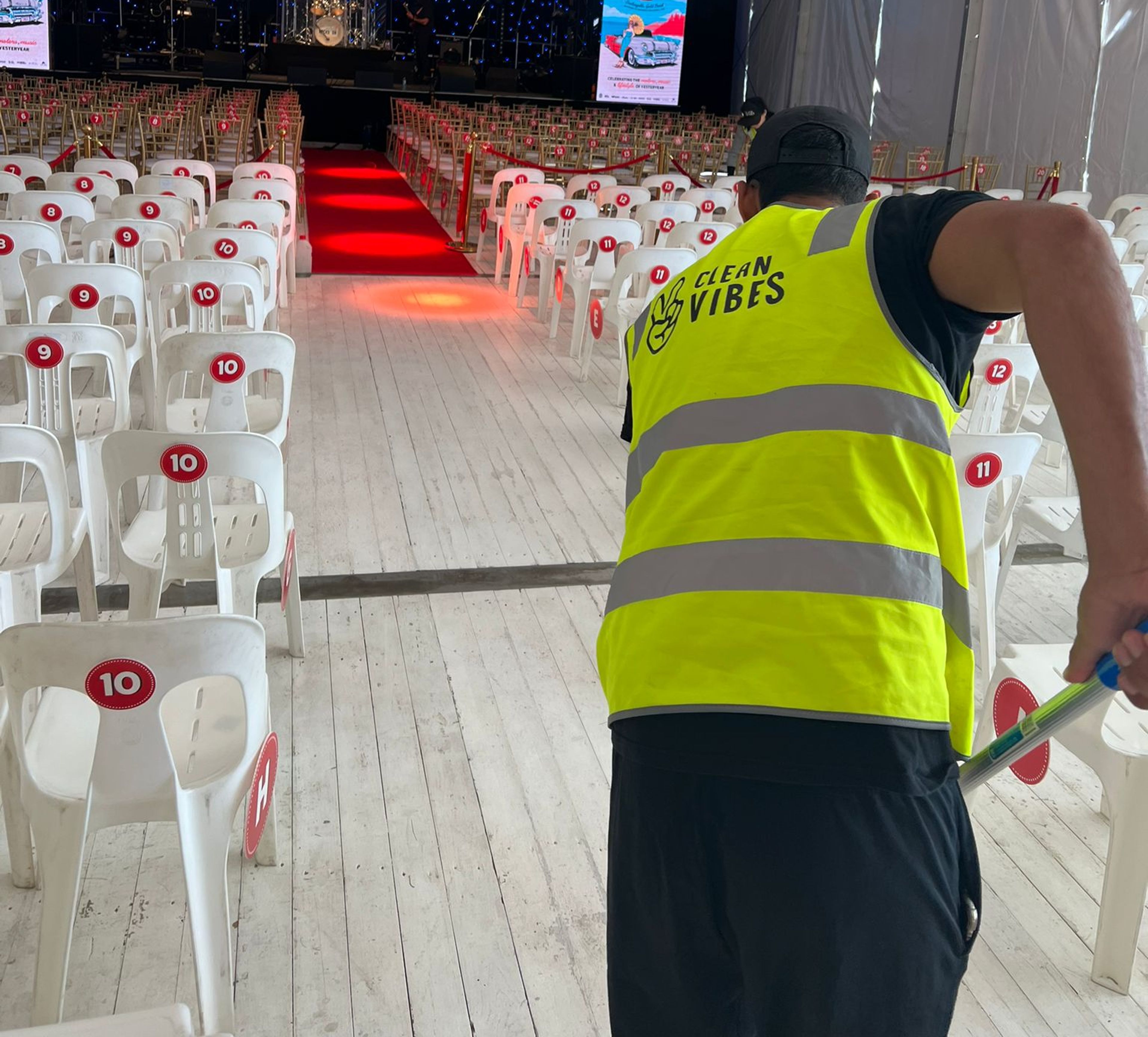Clean Vibes staff mopping floor of indoor venue