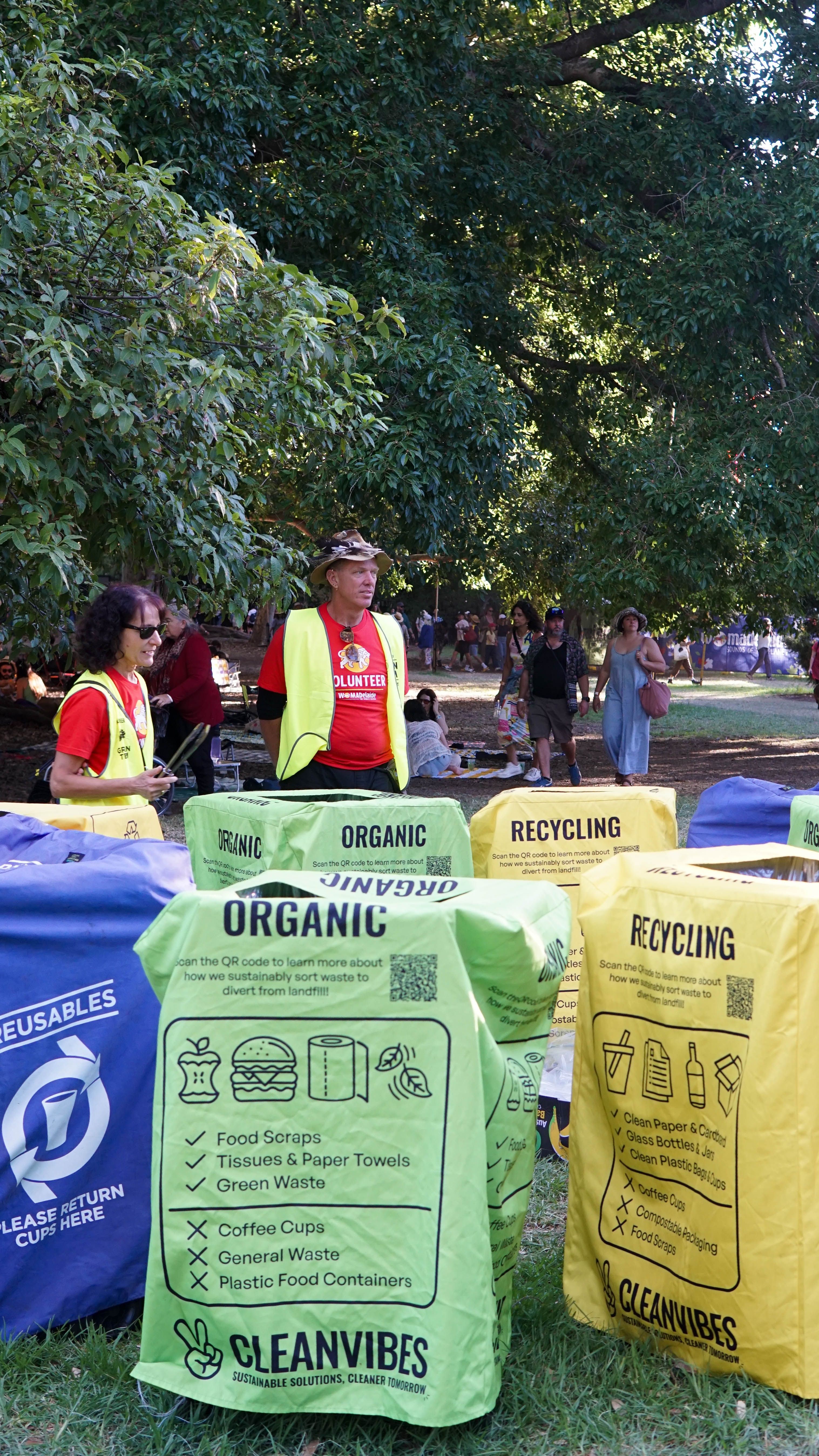 WOMAD Volunteers helping attendees with waste disposal