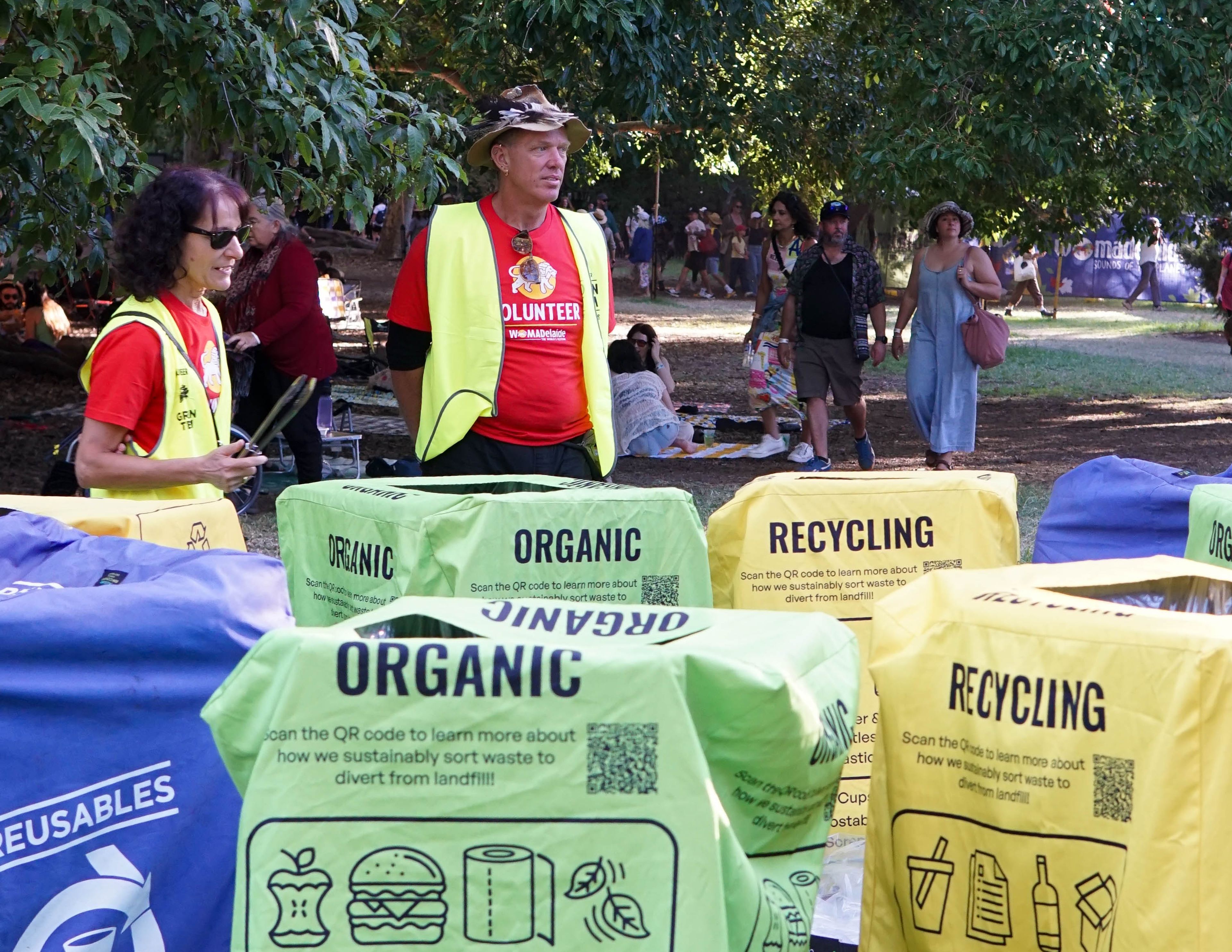 WOMAD Volunteers helping attendees with waste disposal