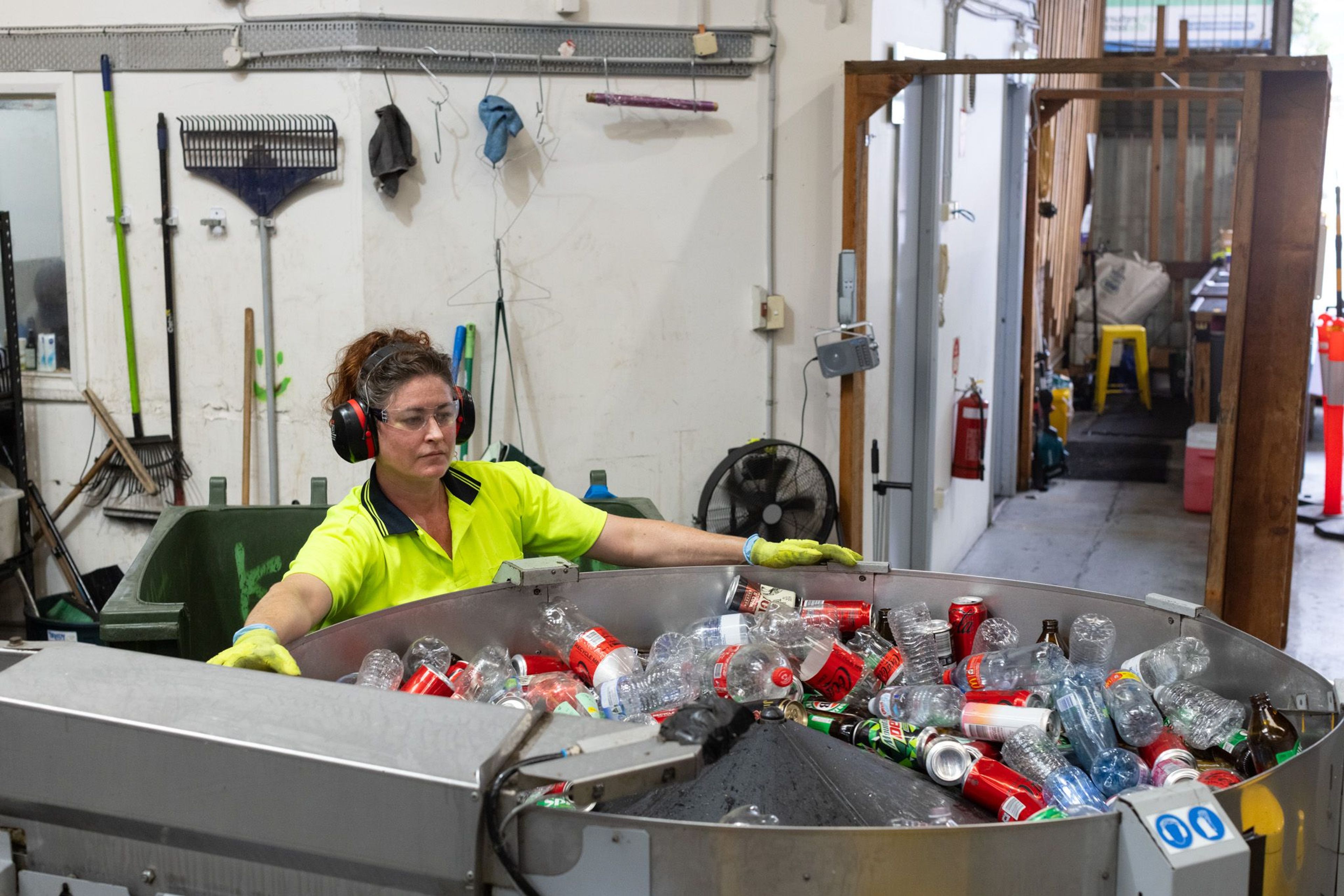 City Return and Earn staff recycling empty cans and plastic bottles