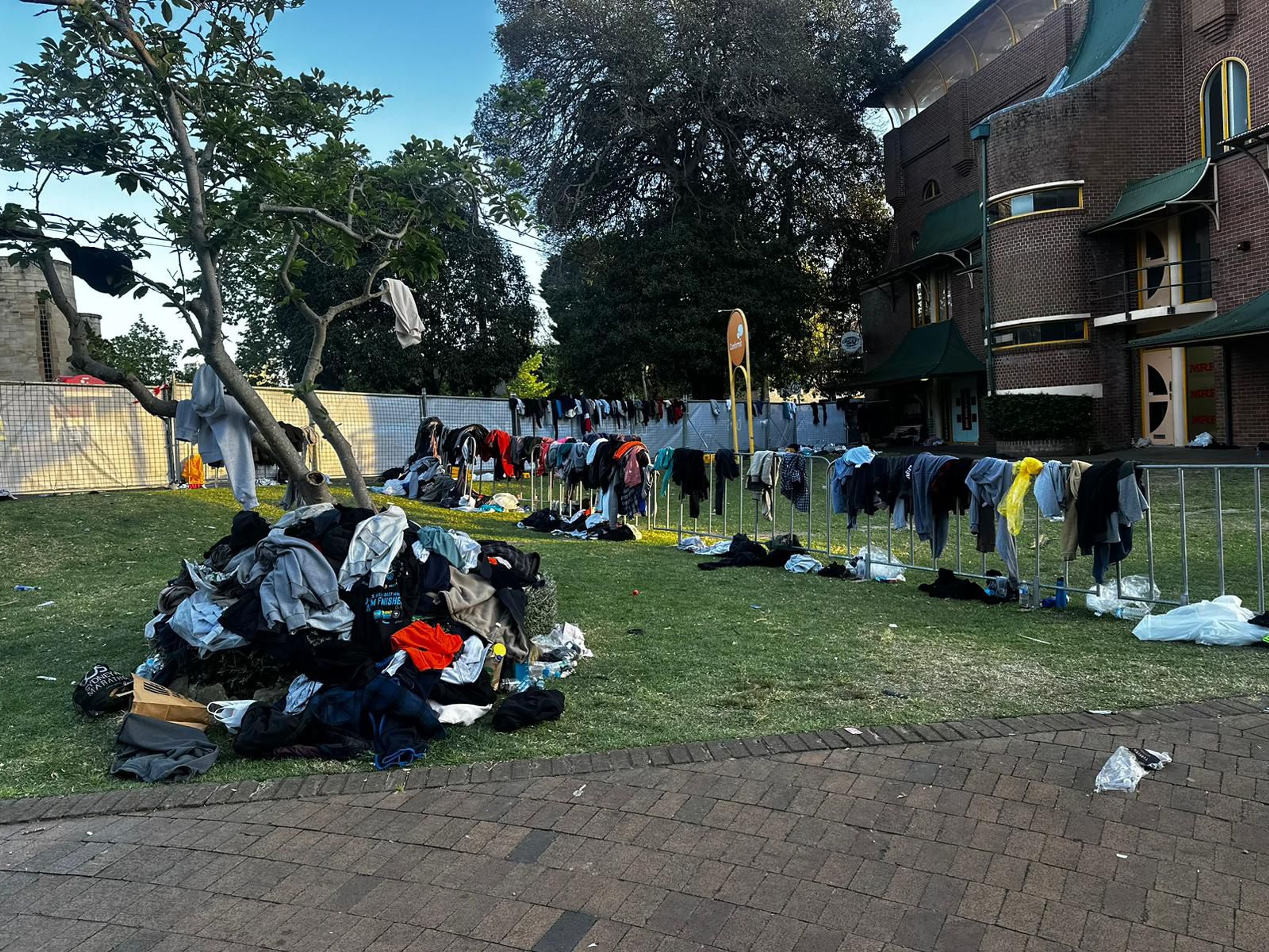 Clothes hanging on fence and grass