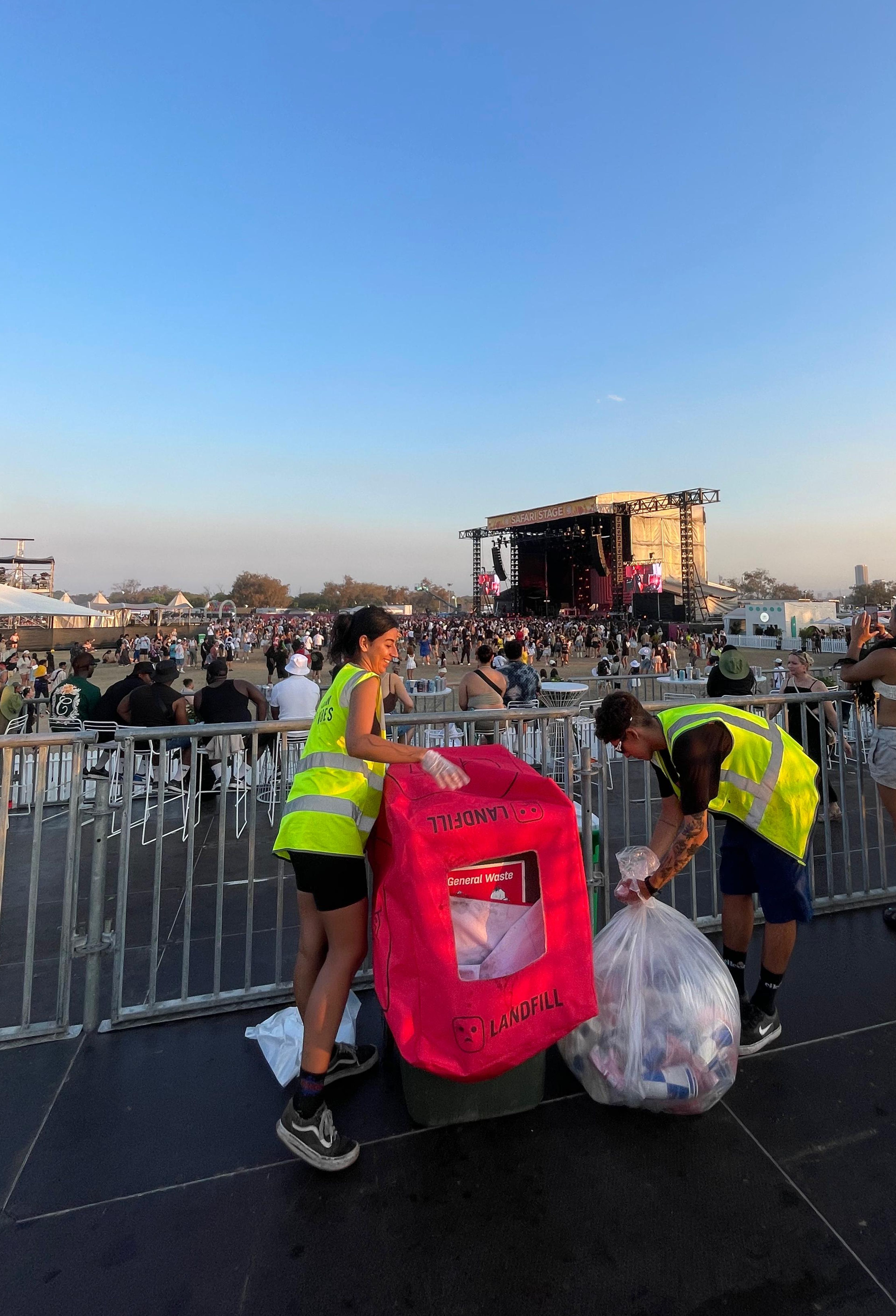 Clean Vibes employees changing bin's bag and adding a red bin cover