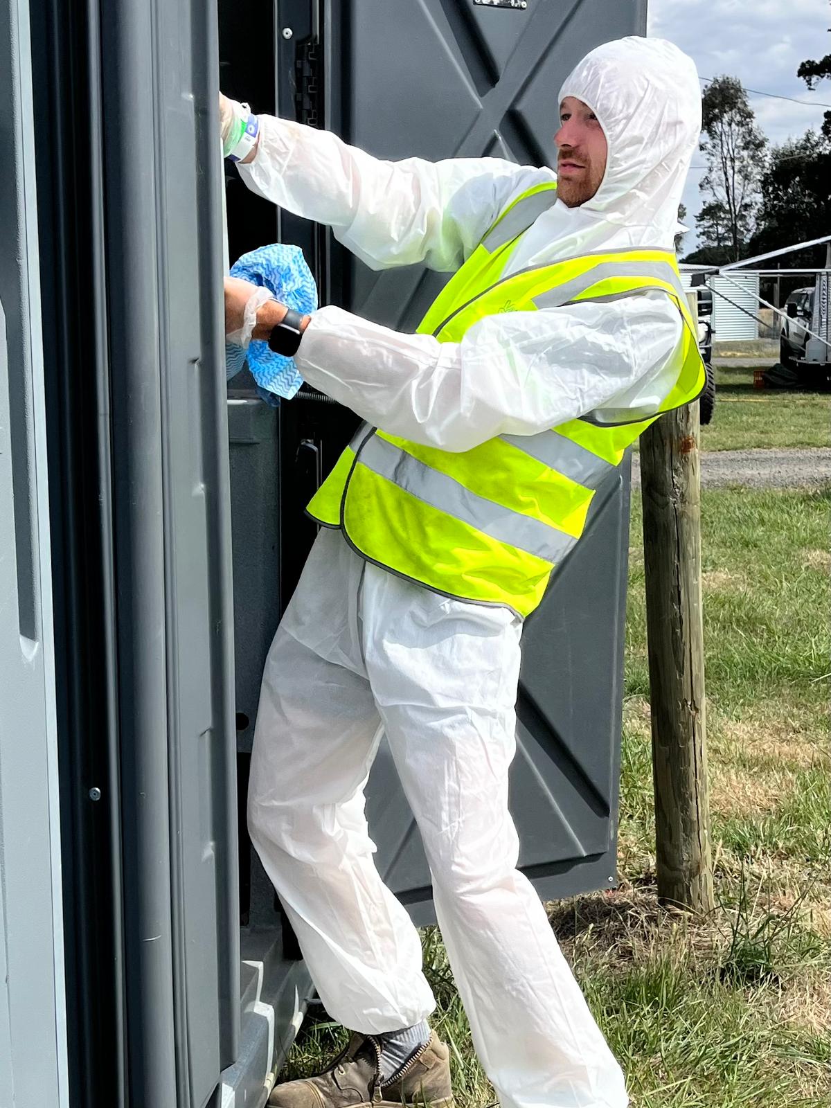Clean Vibes team member wearing hazmat suit cleaning