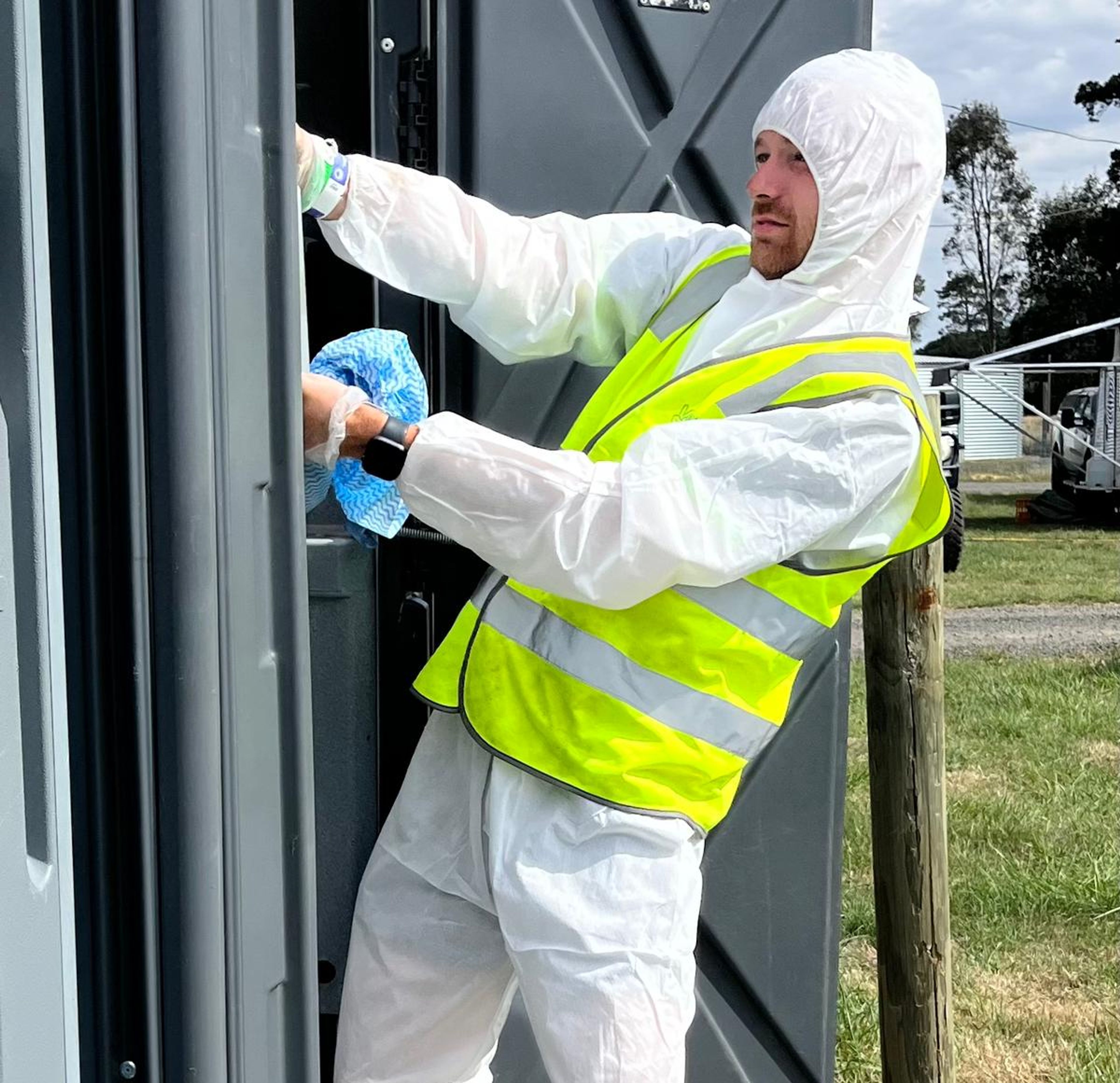 Clean Vibes team member wearing hazmat suit cleaning