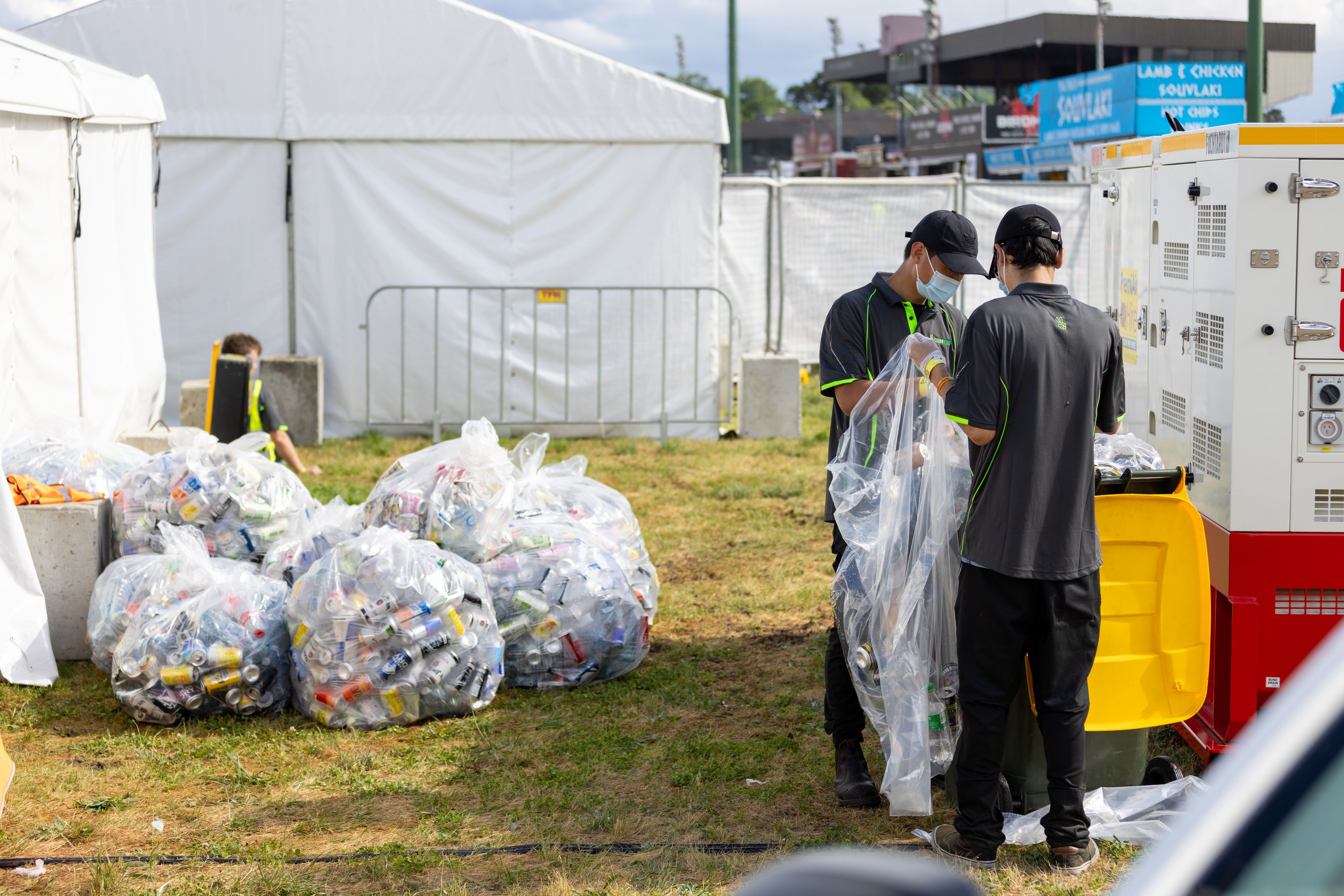 Clean Vibes employees at back of house sorting trashes into correct bins