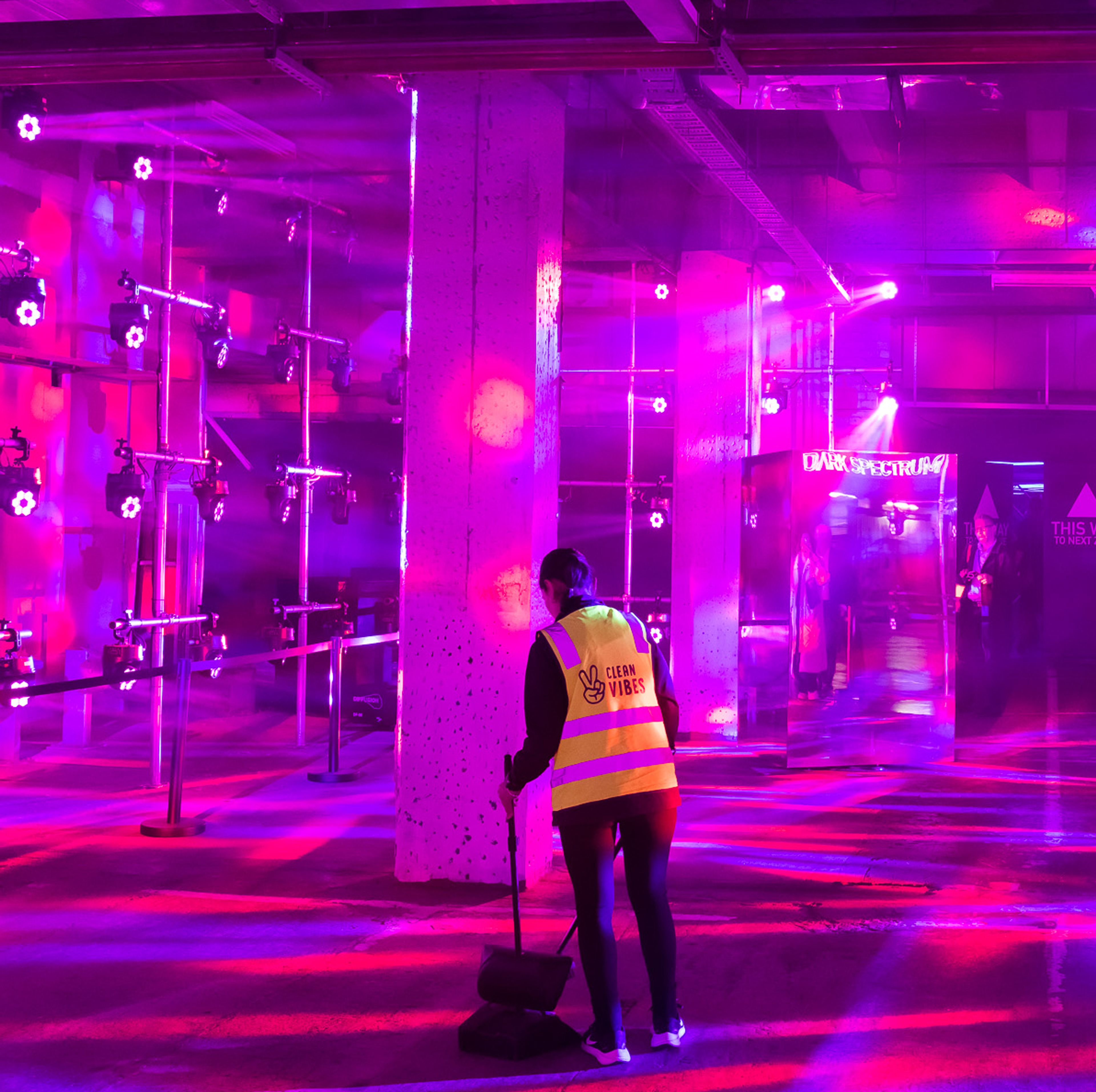 Clean Vibes staff cleaning floor of the venue by night