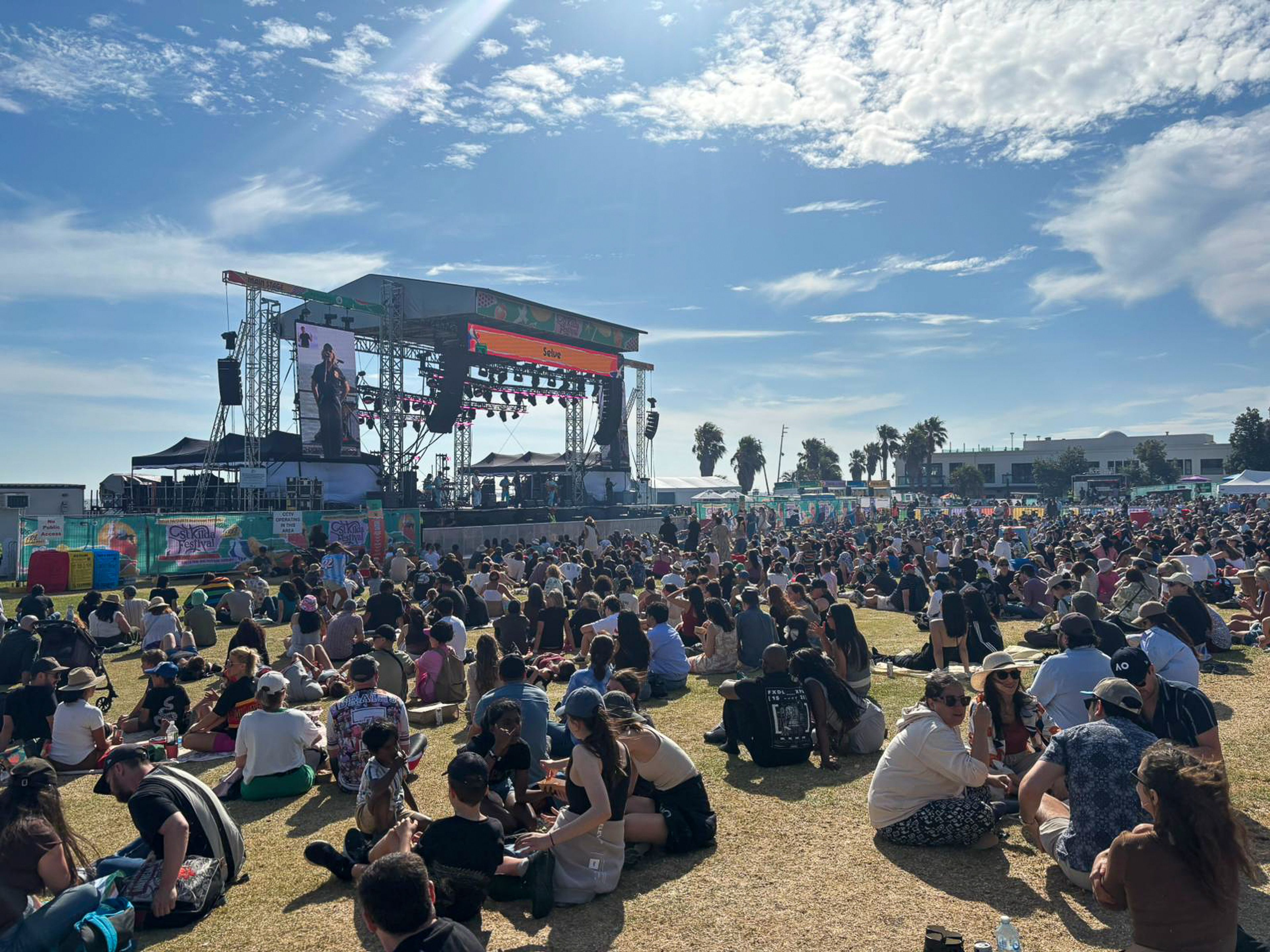 People waiting at a St Kilda Festival stage