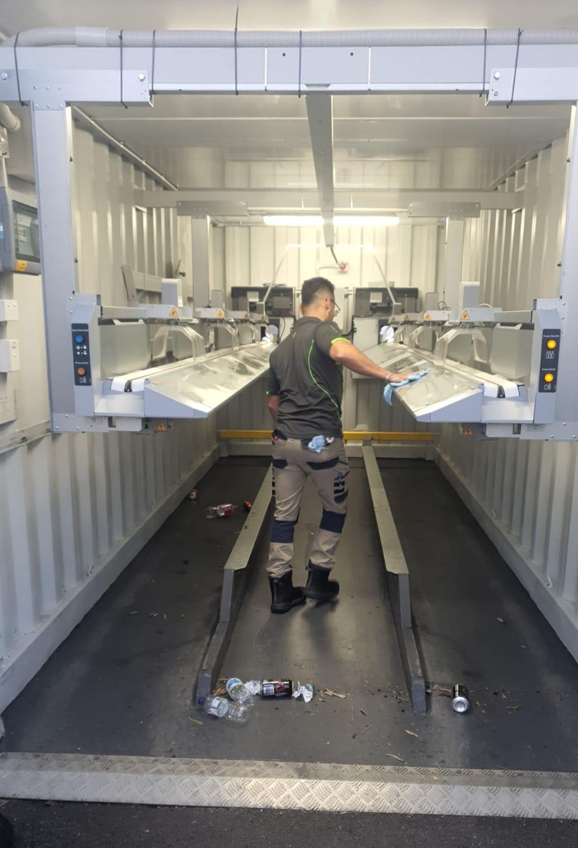 Clean Vibes employee cleaning the inside of a machine