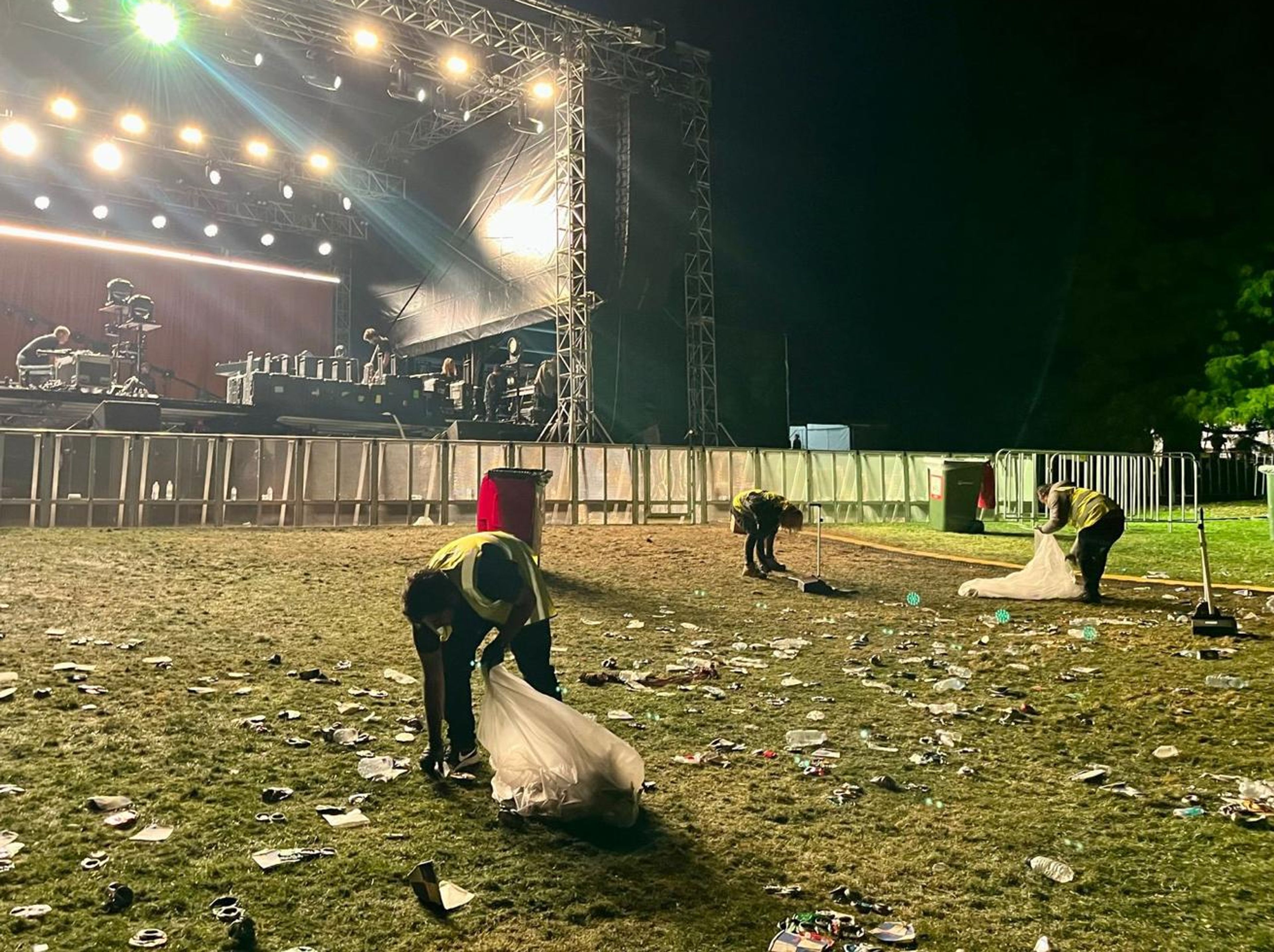 Clean Vibes staffs removing trashes from the ground after event