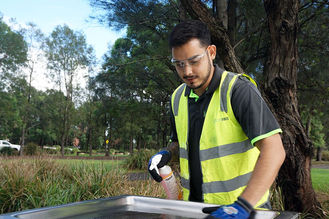 Staff cleaning BBQ