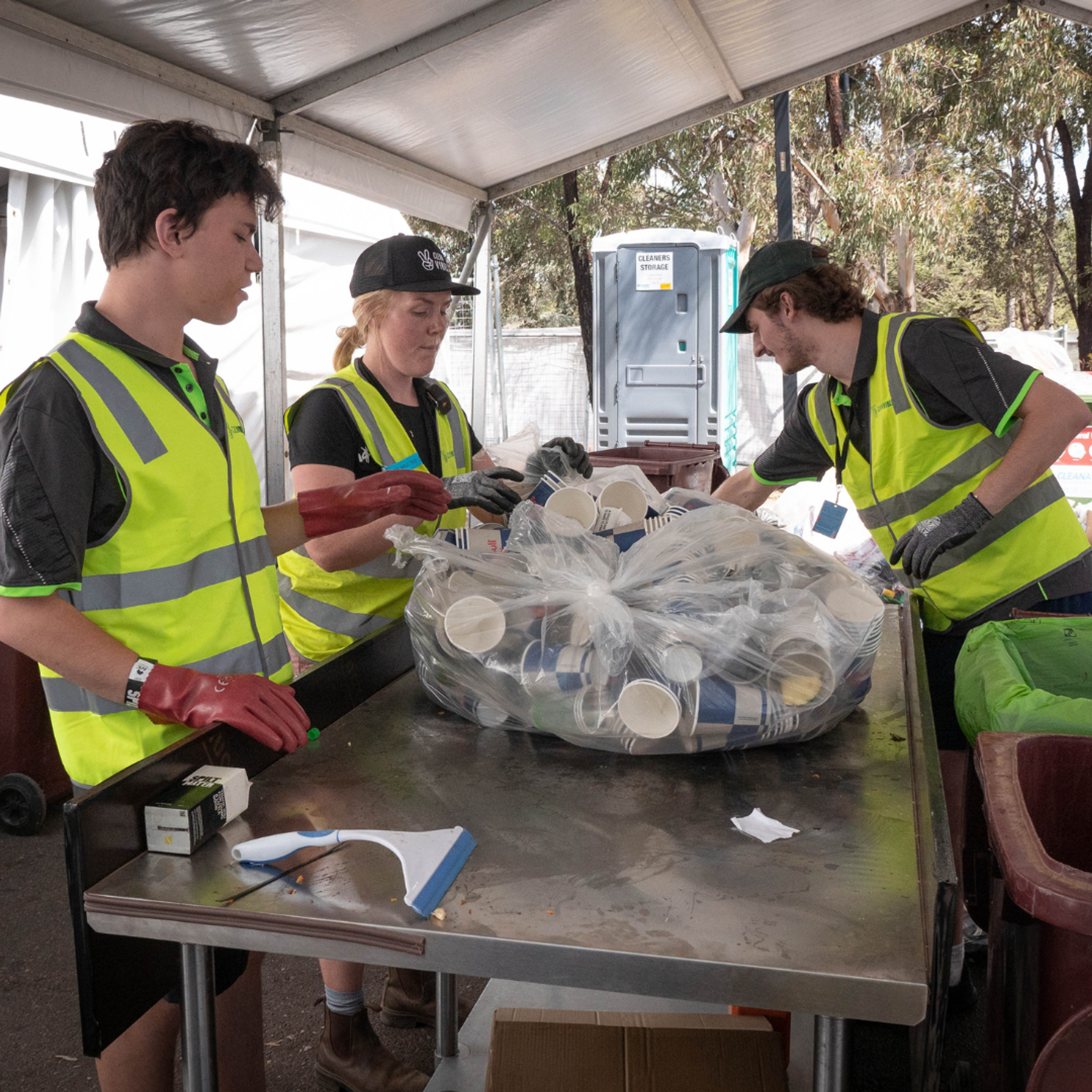 Clean Vibes staffs sorting cups and other items at compound