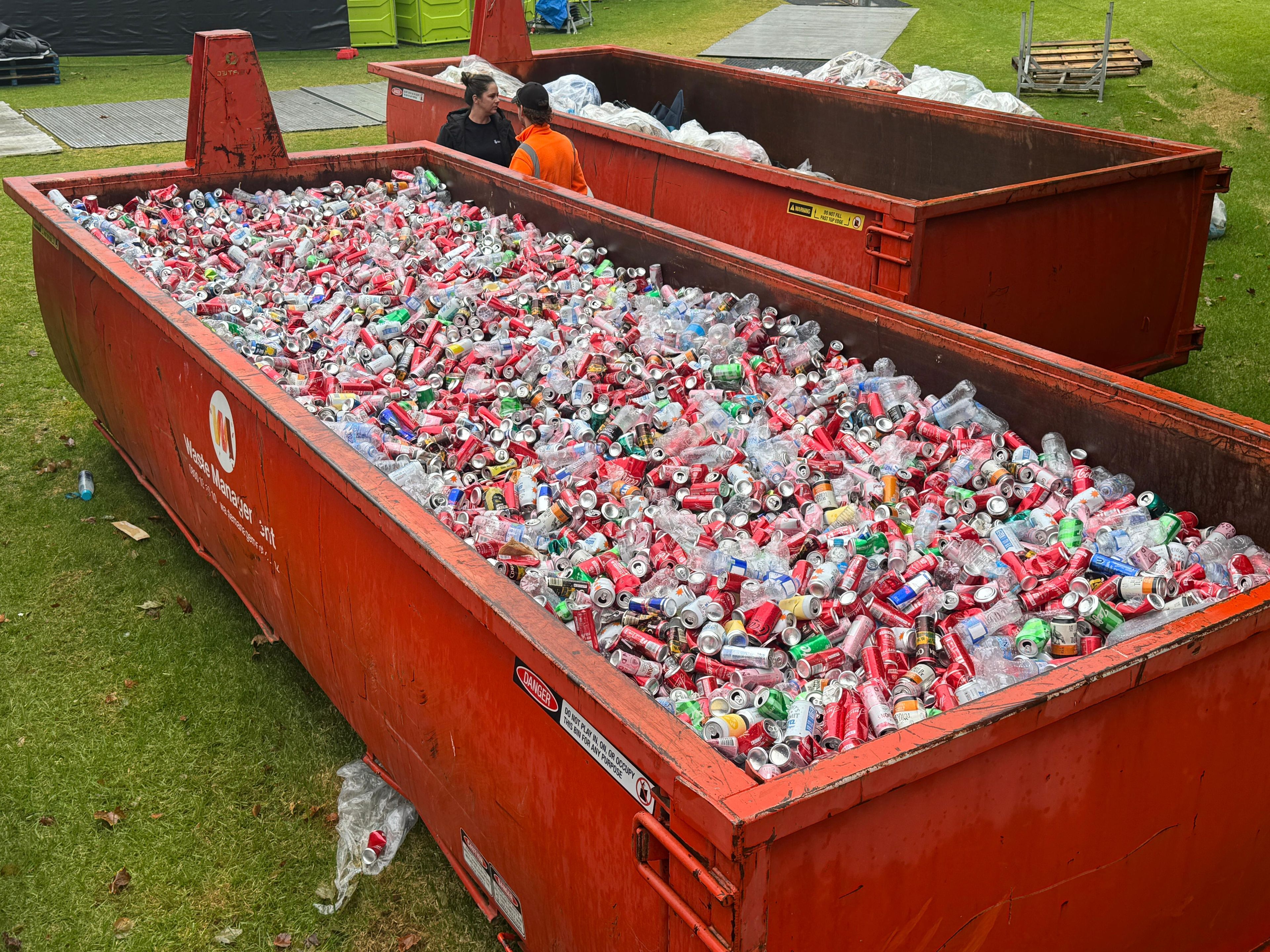 Thousands of cans and plastic bottles in a skip