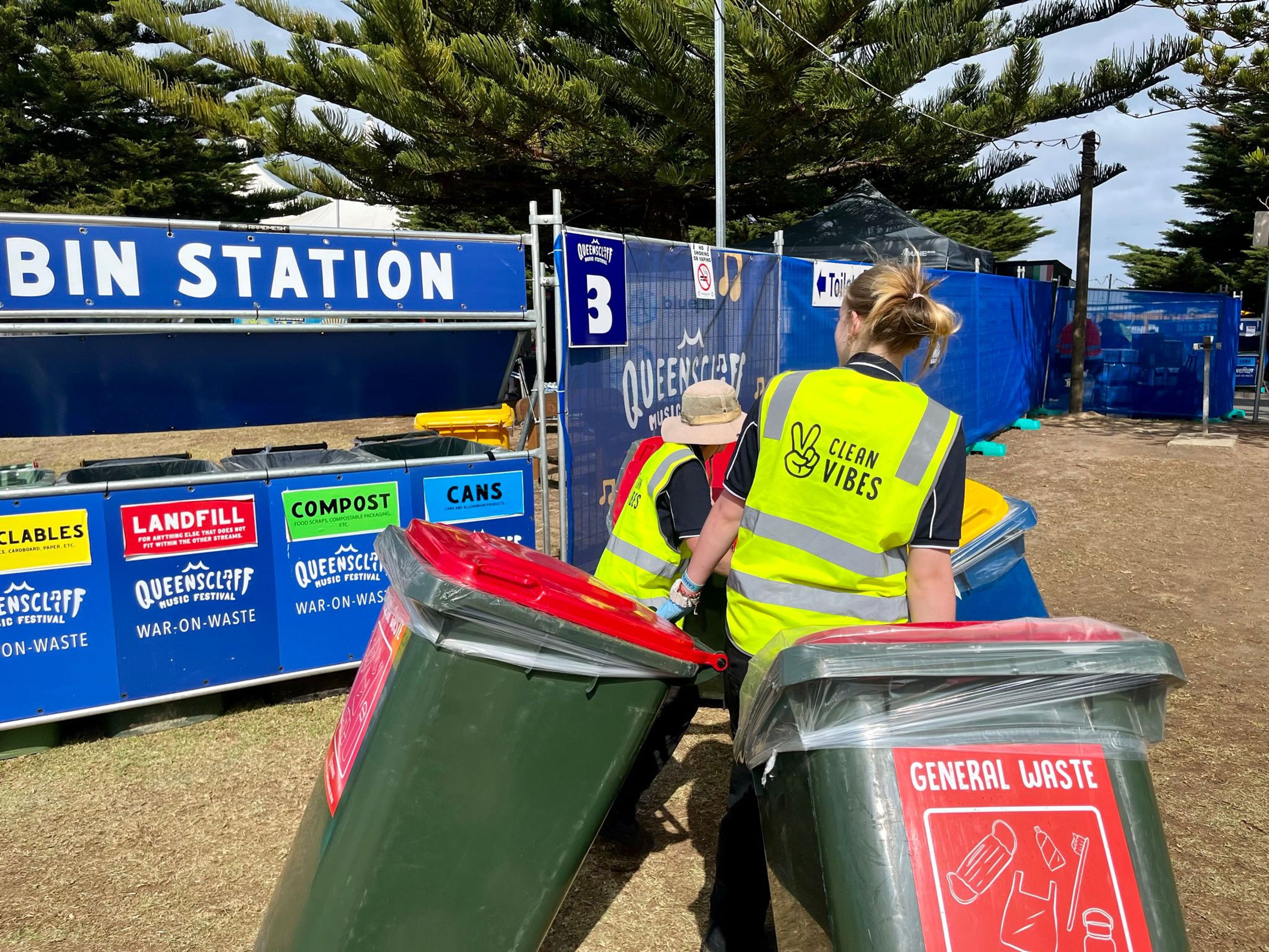 Clean Vibes employees passing by the bin station of the event