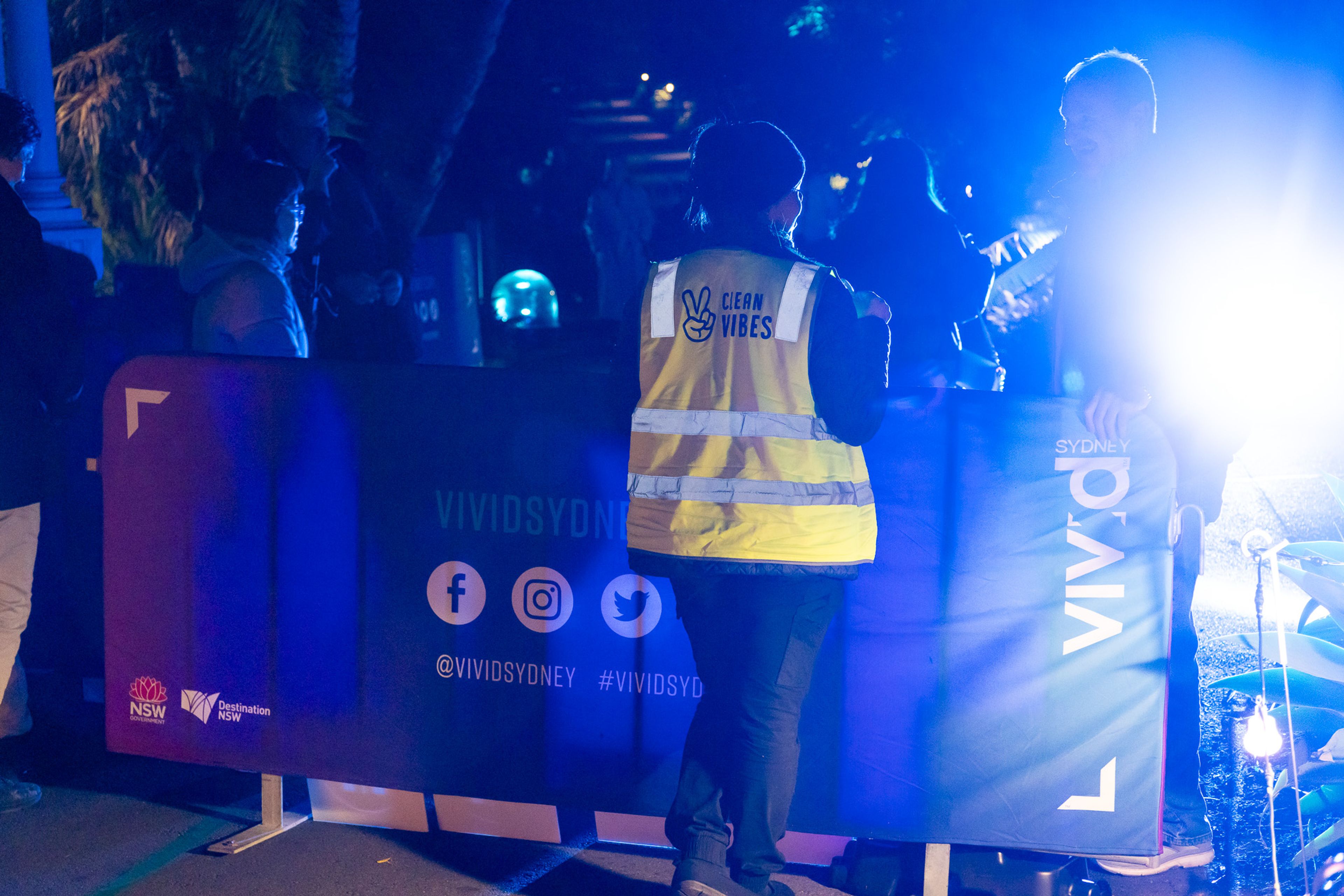 Clean Vibes employee talking to a patron in the street at vivid Sydney