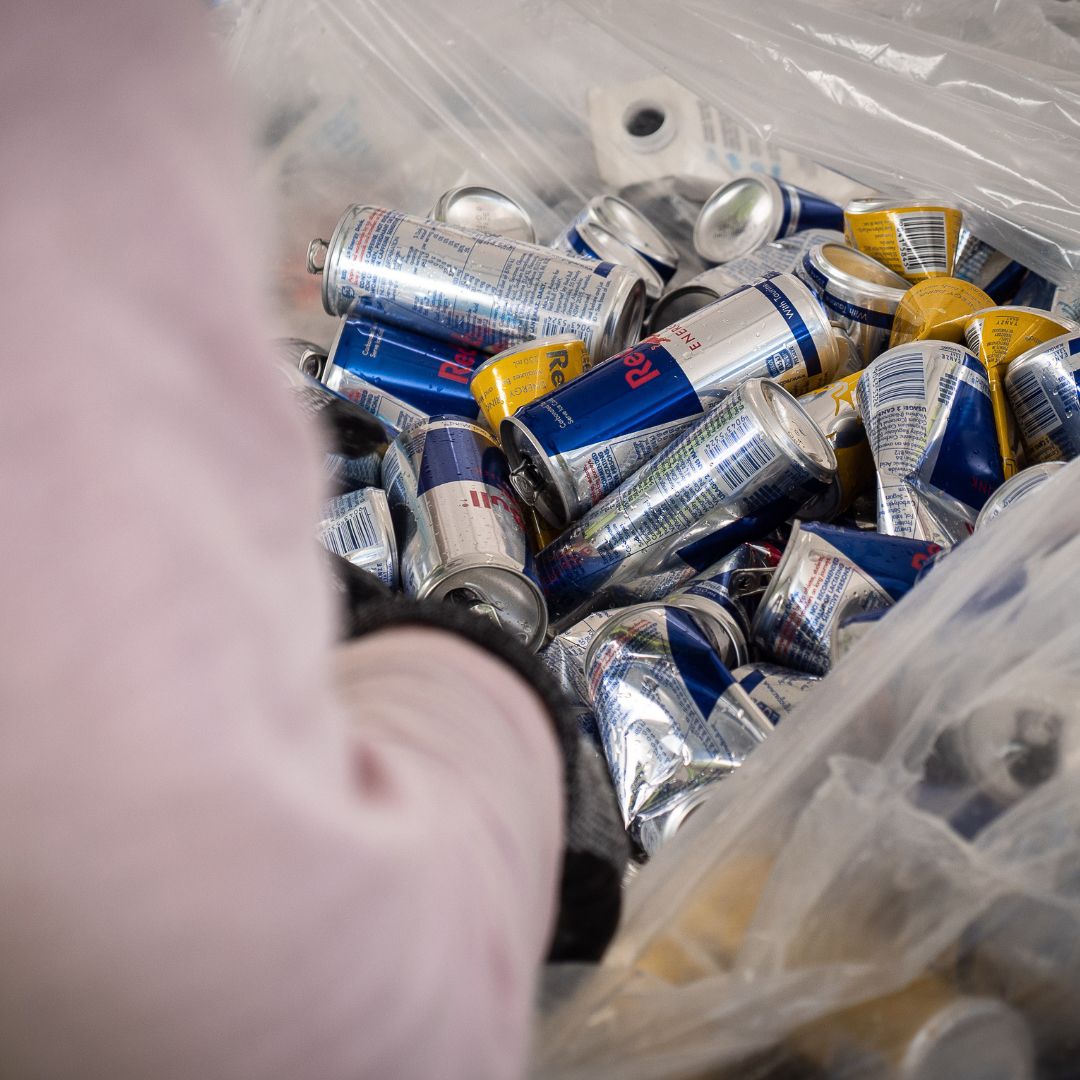 Staff sorting through bag of drink containers 