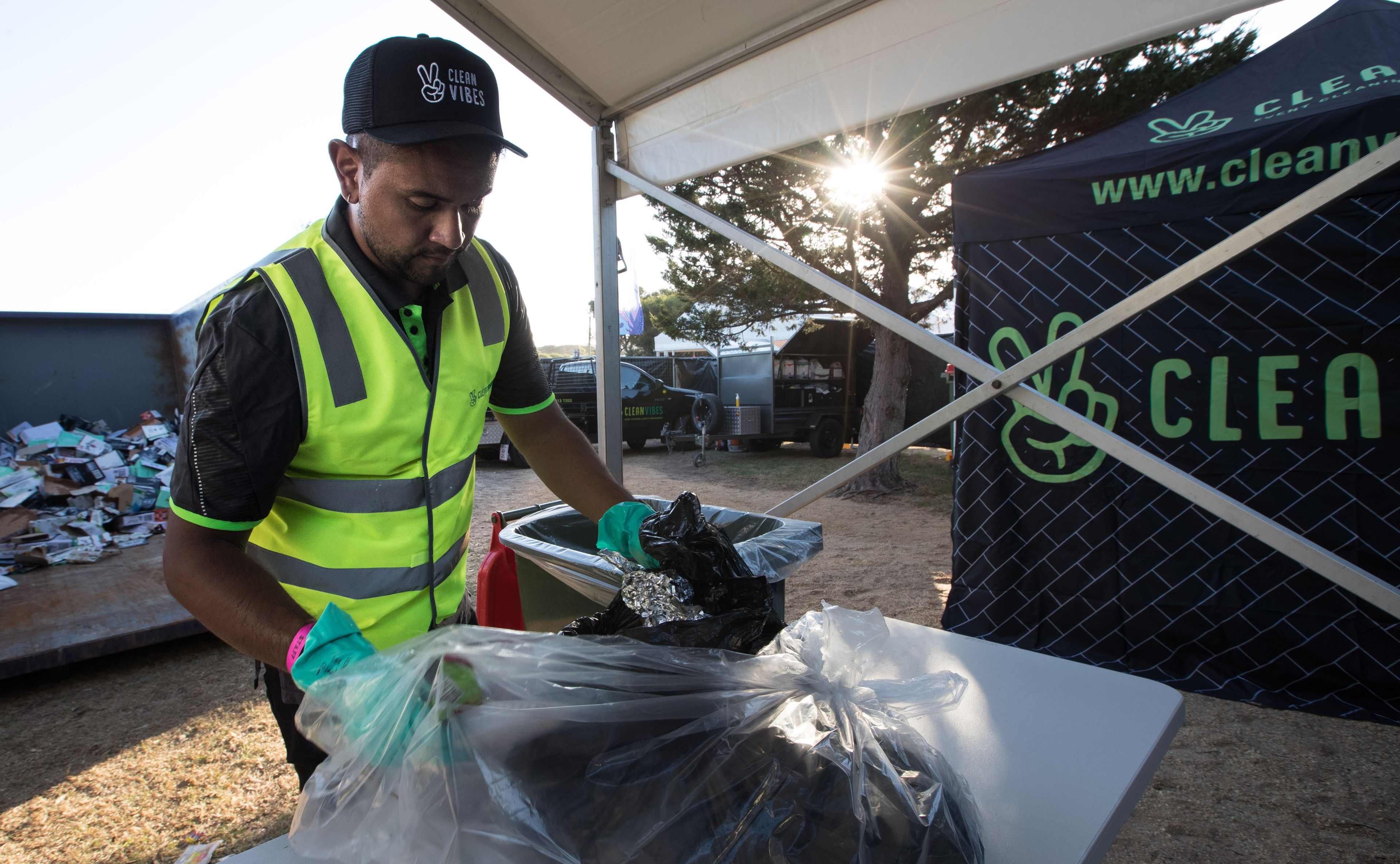 Clean Vibes staff sorting trash at compound