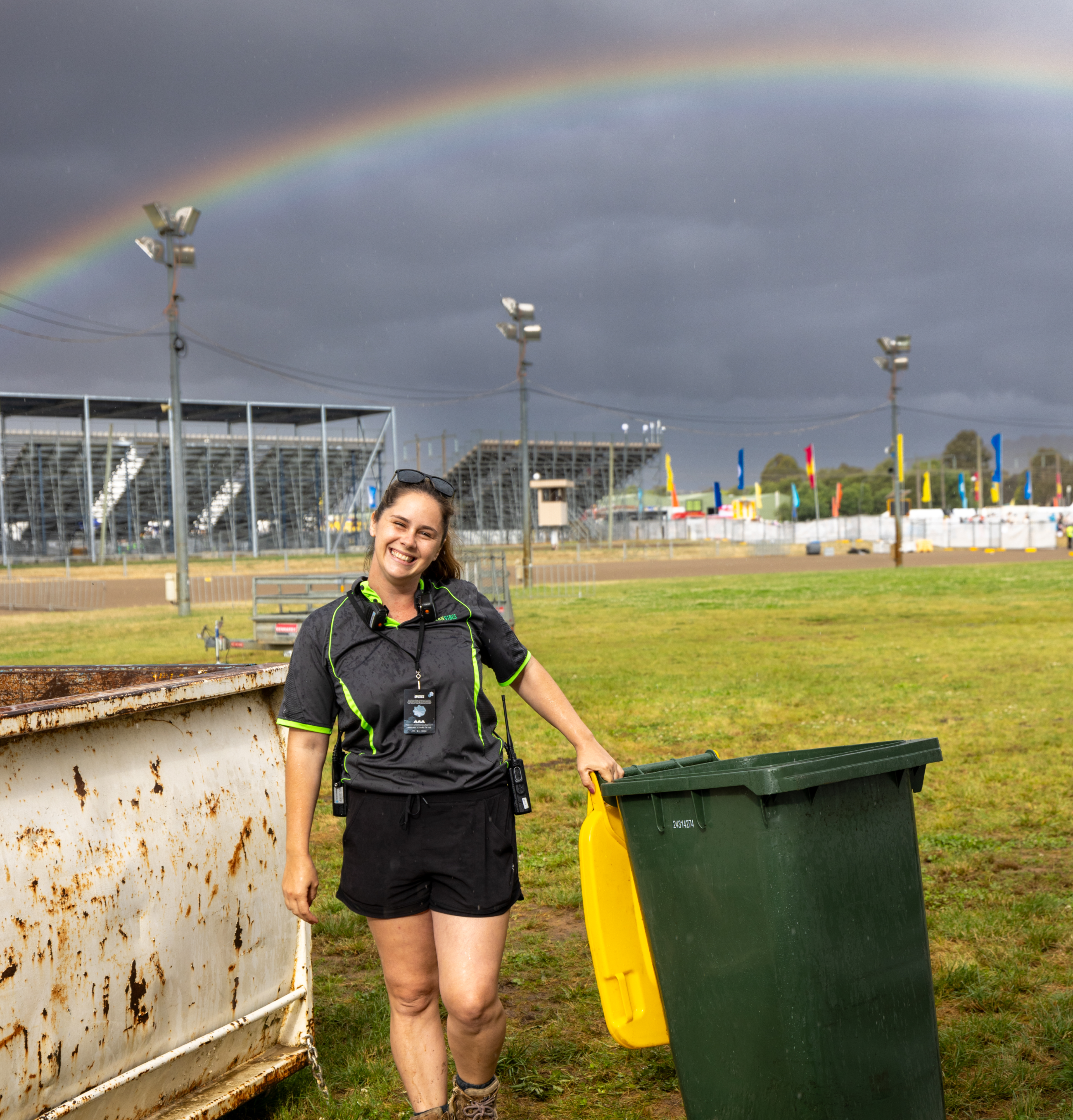 Clean Vibes happy staff working at an event with rainbow in the background