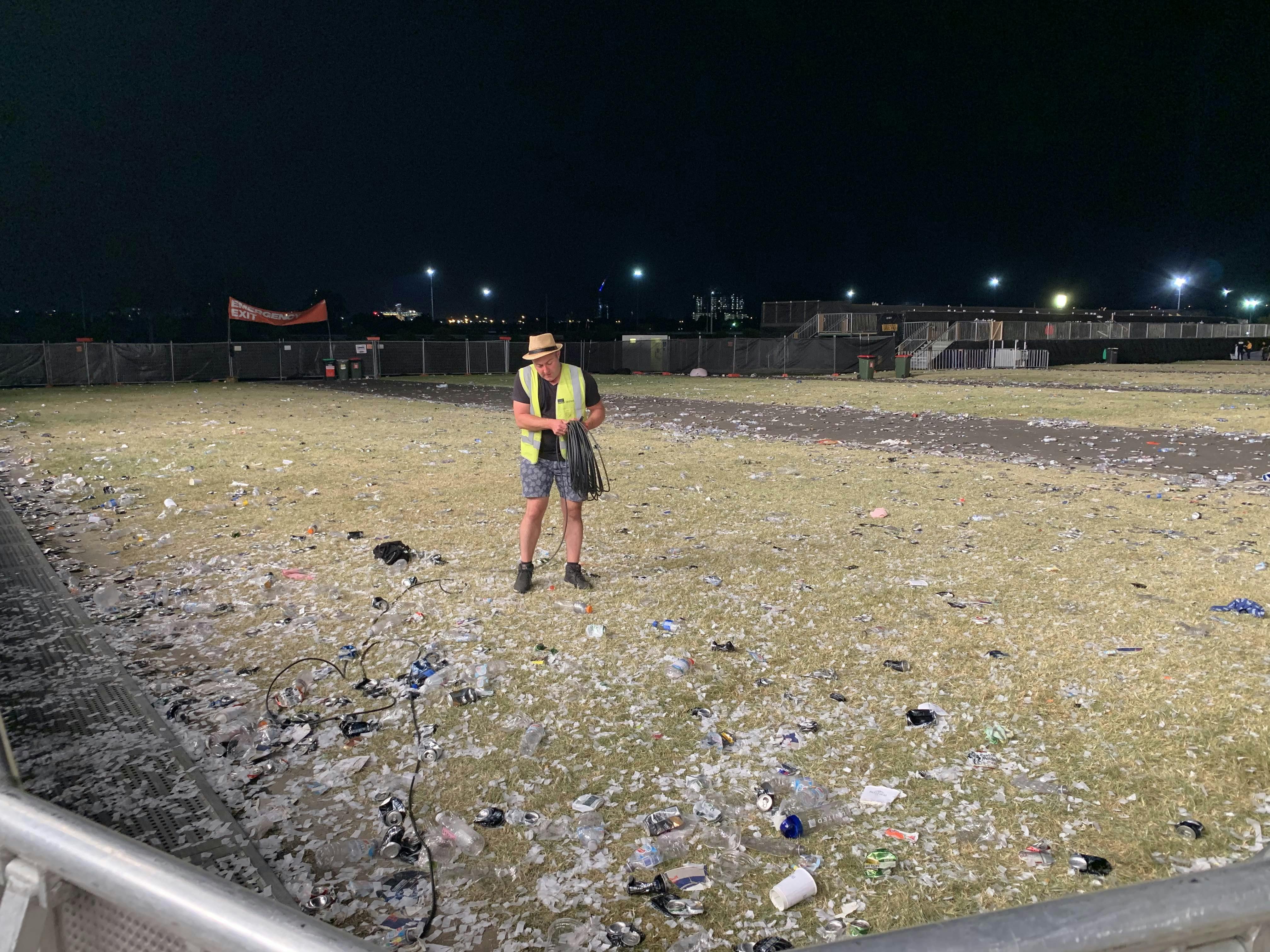 Clean Vibes staff surrounded by trashes on the floor post event