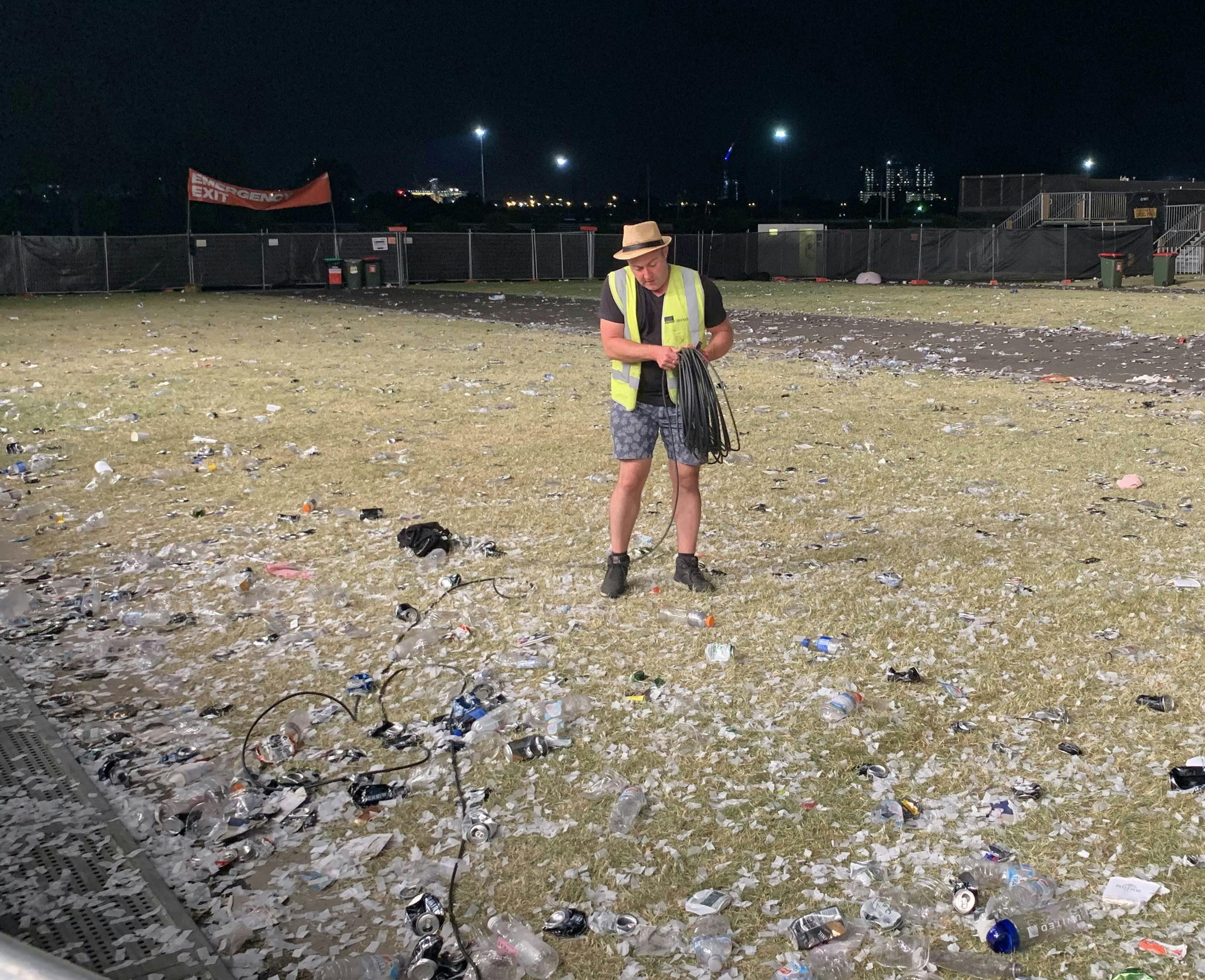 Clean Vibes staff surrounded by trashes on the floor post event