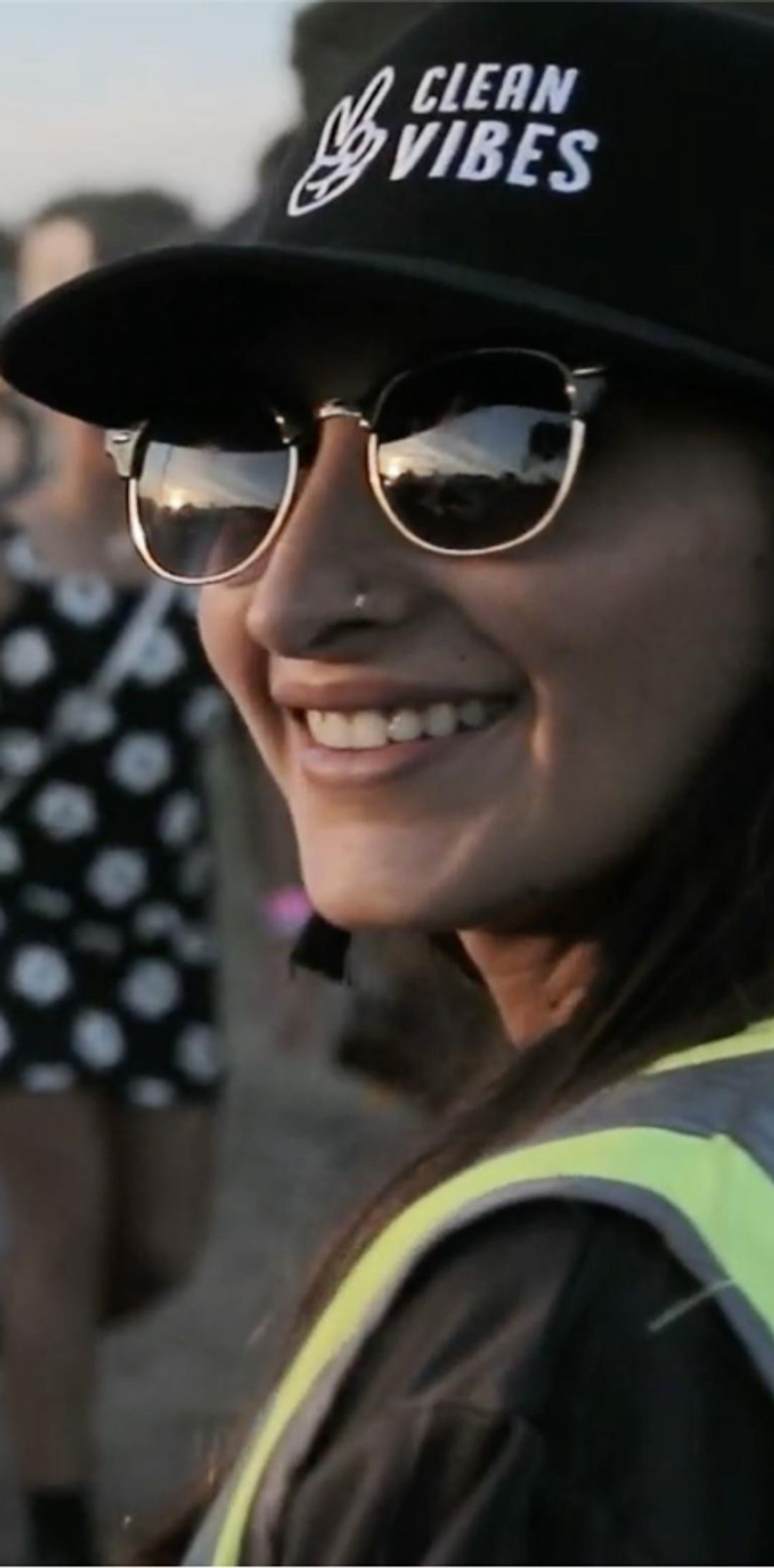 Person smiling while wearing a Clean Vibes hat