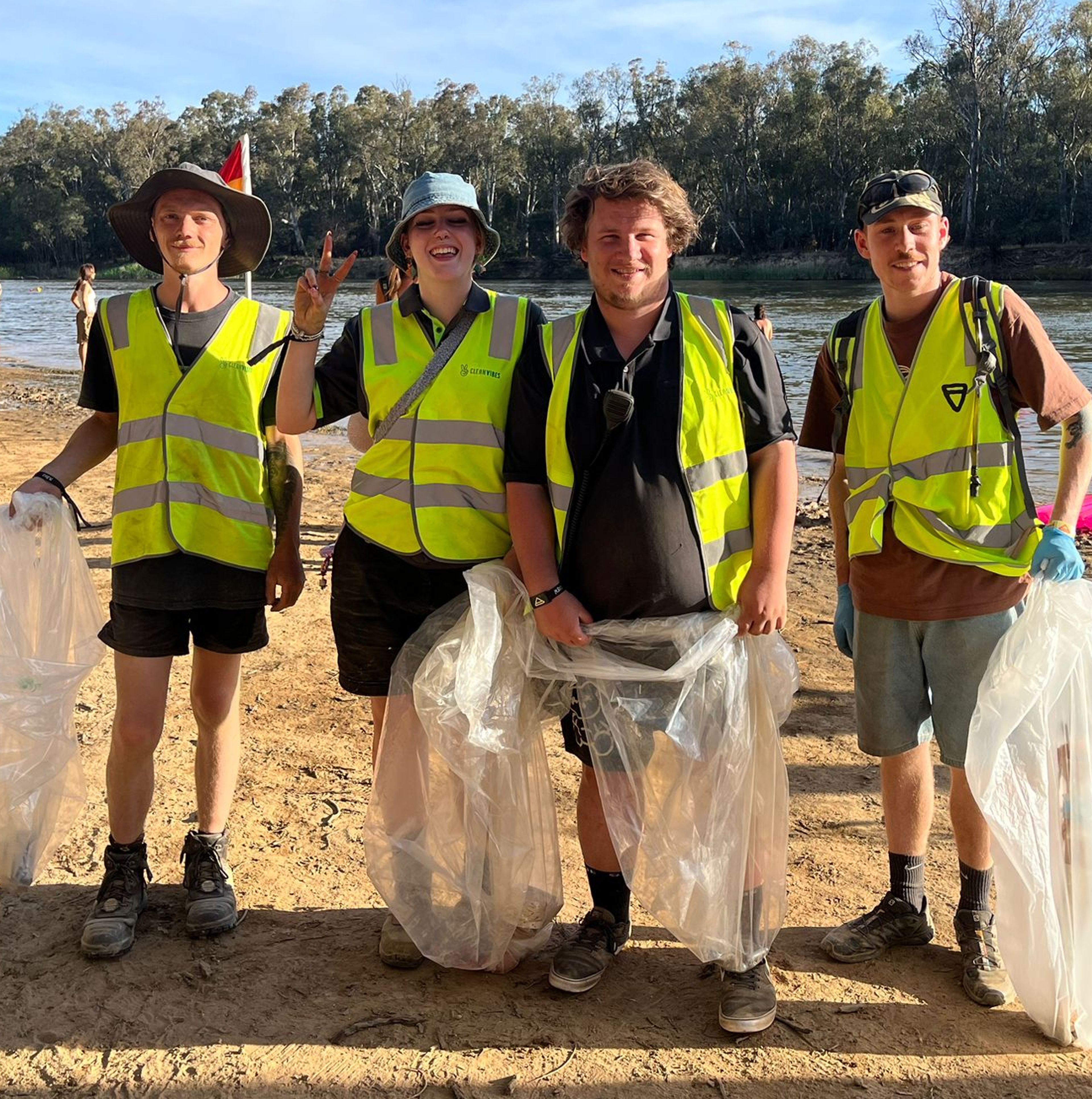 Clean Vibes team with bags to remove waste from the floor at festival