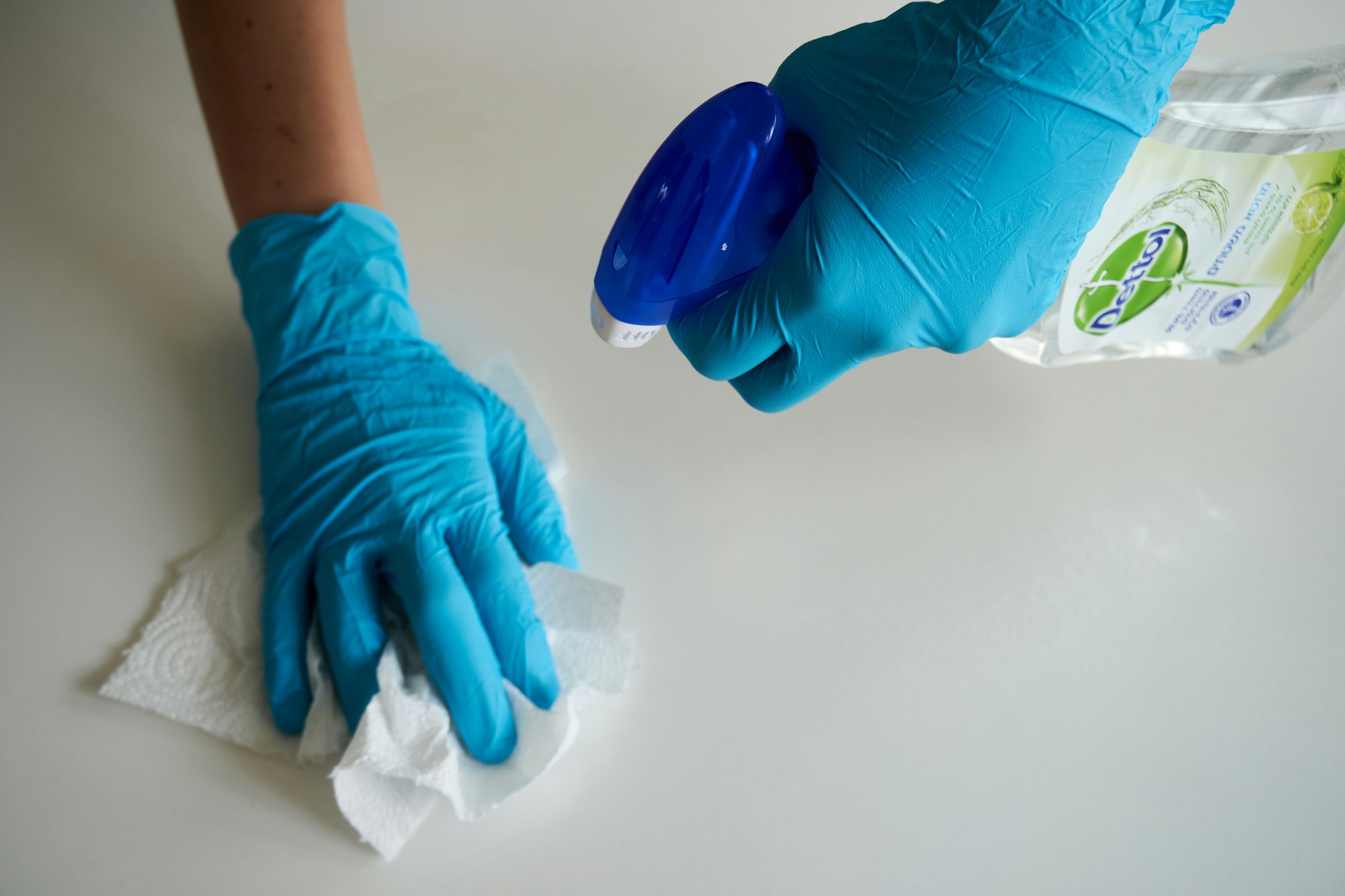 Using disinfectant to clean surfaces