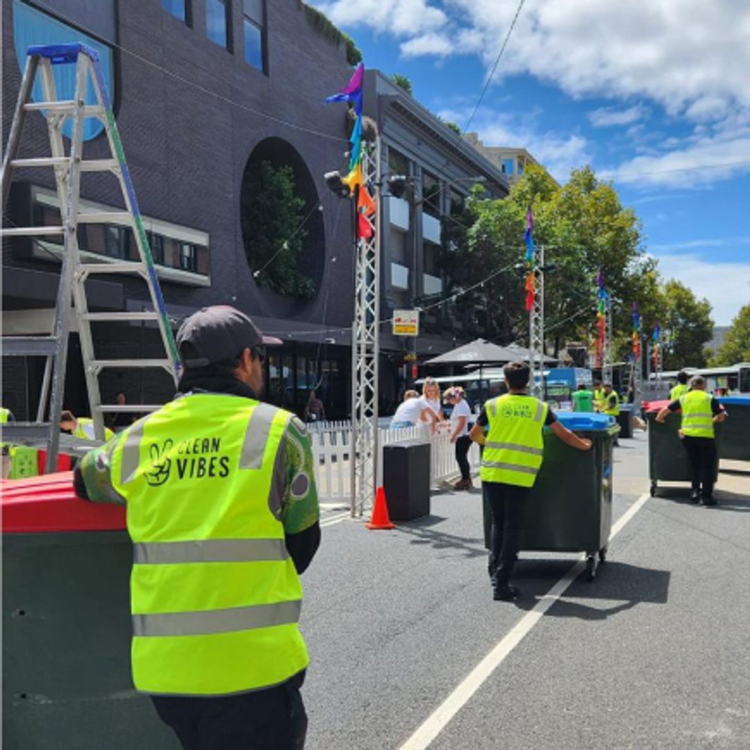 Clean Vibes employees moving wheeling bins