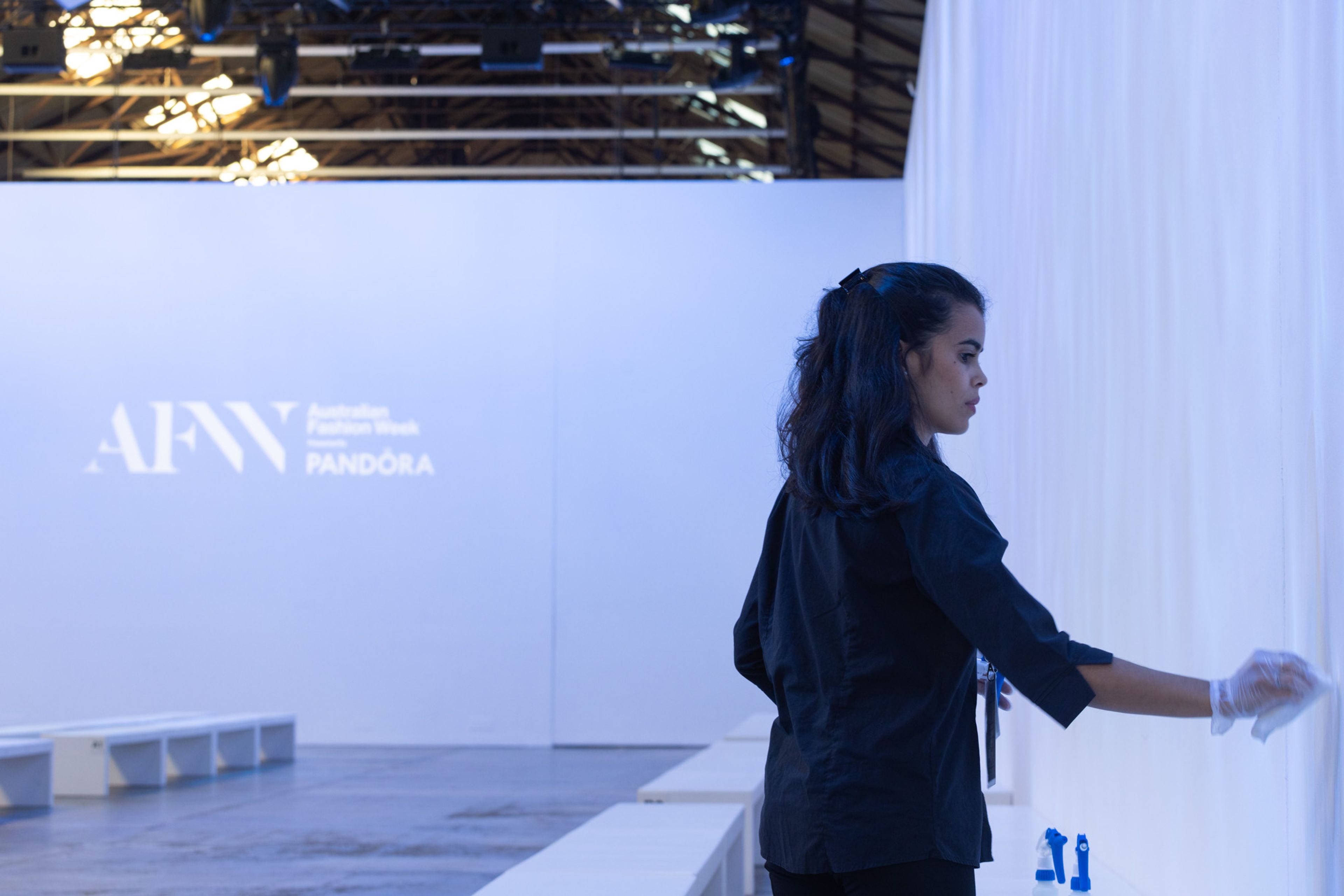 Clean Vibes' staff cleaning a wall of a venue at Sydney Fashion week 2024