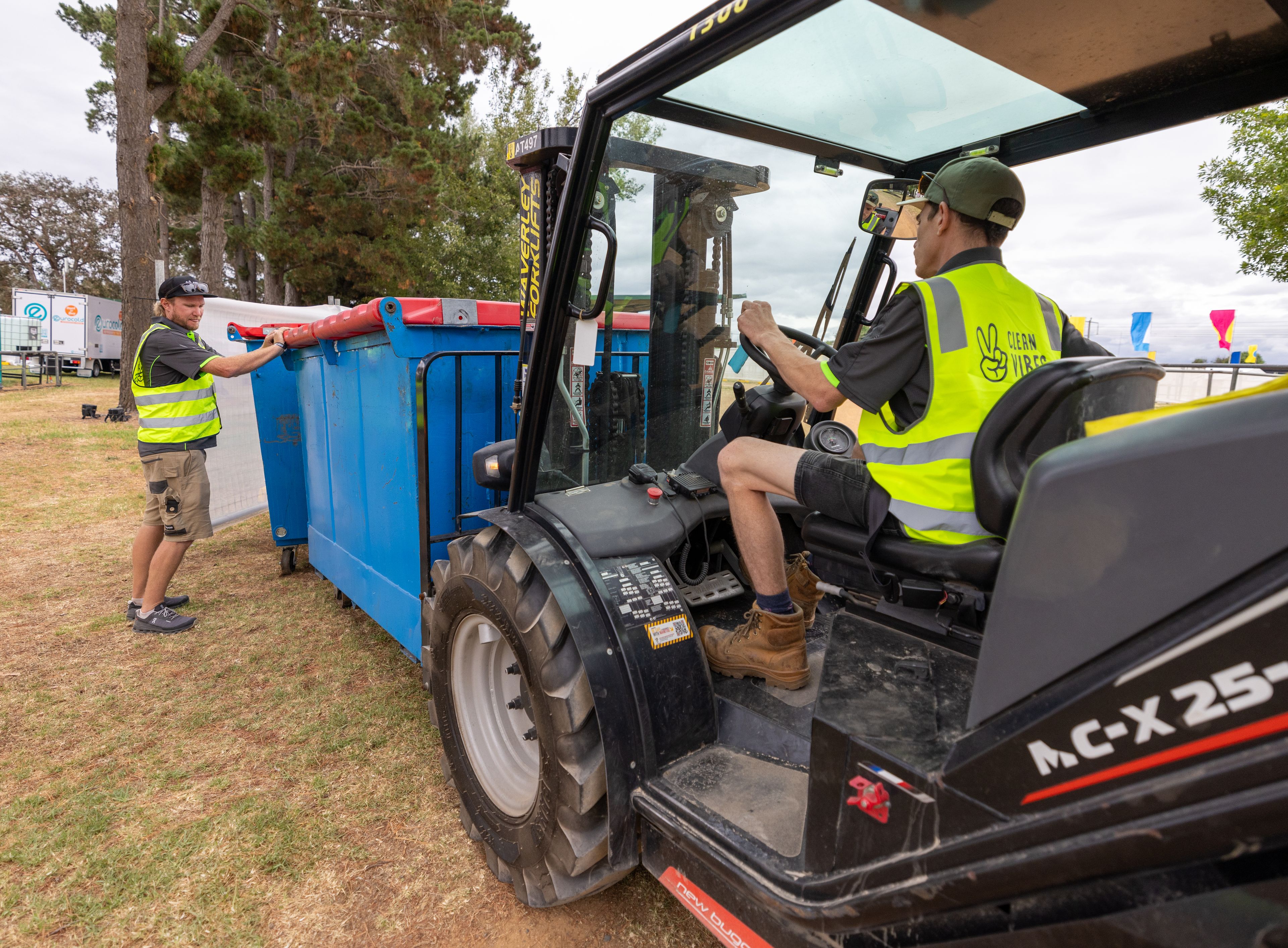 Clean Vibes employees manipulating a forklift