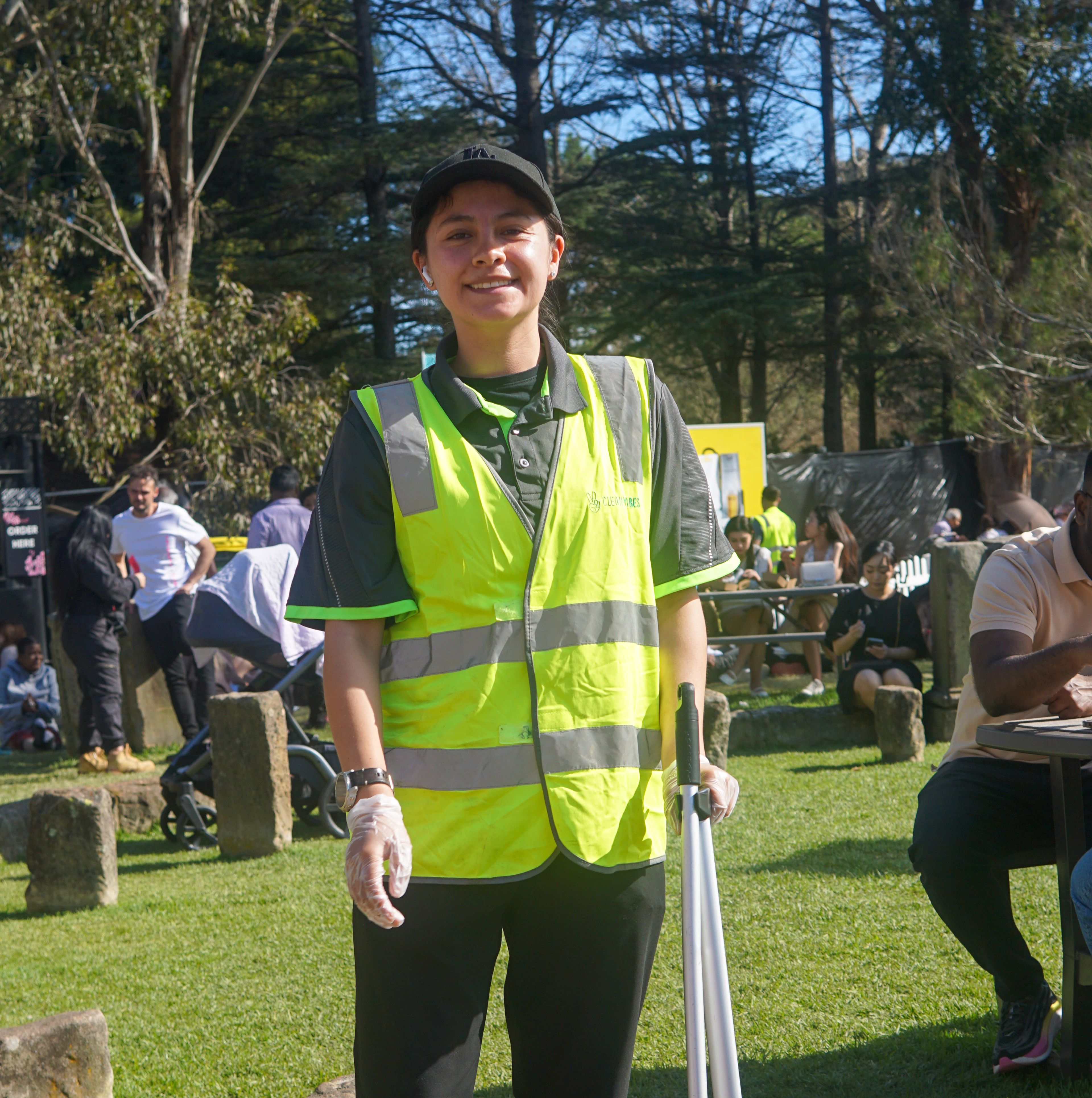 Clean Vibes staff cleaning grass area at a festival