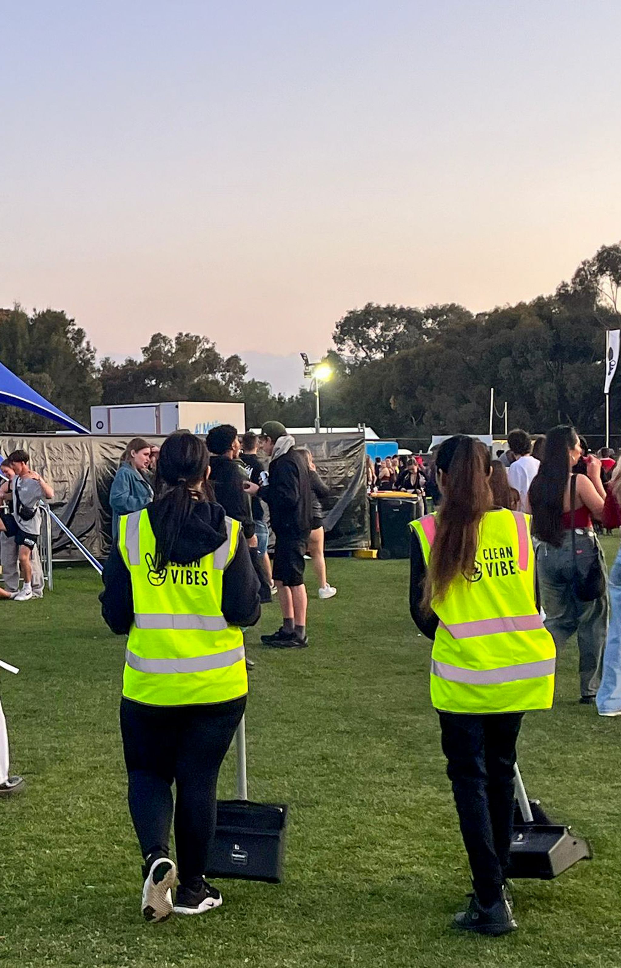 Clean Vibes staffs walking around the festival with brooms