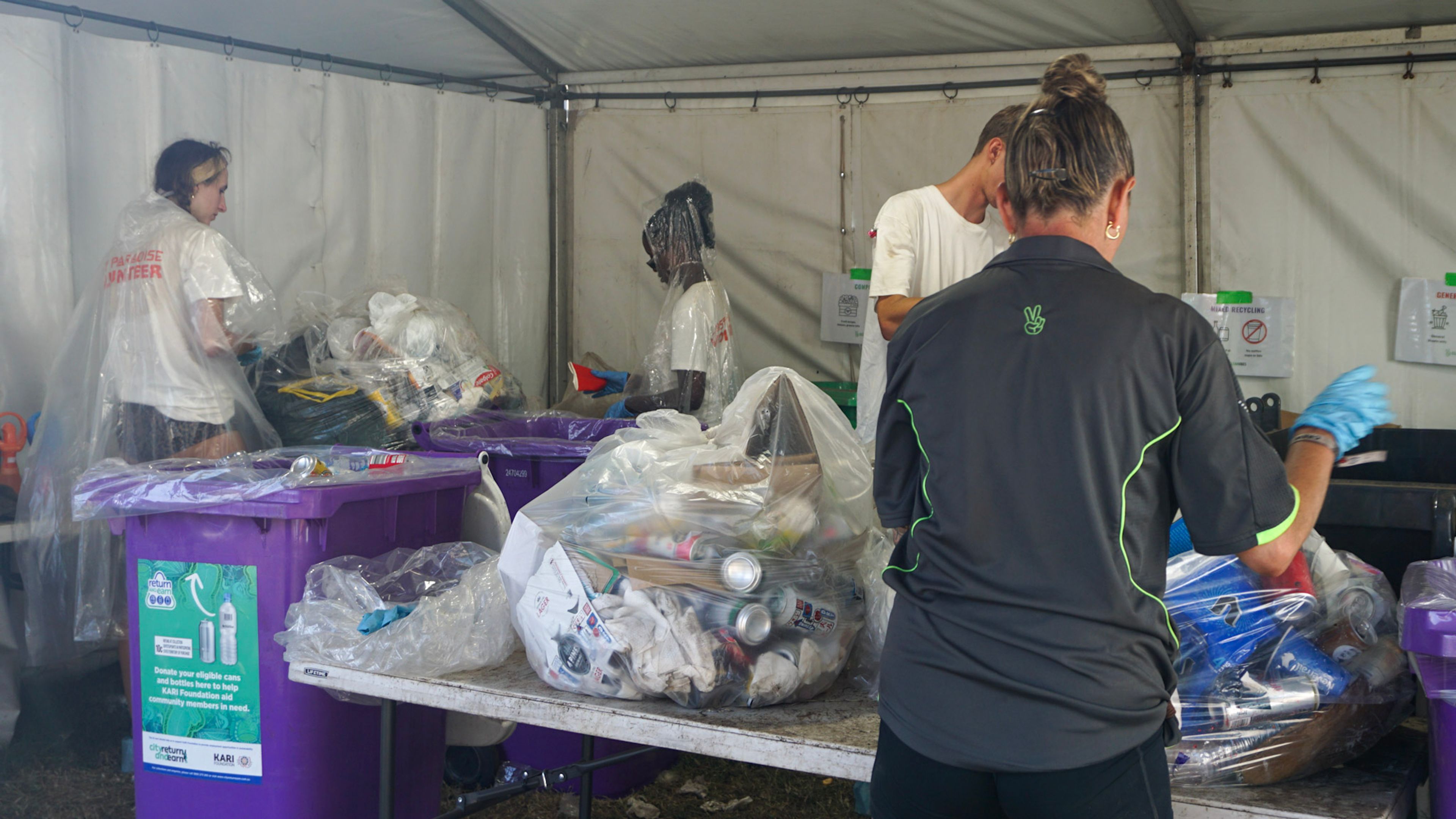 Staff and volunteers waste-sorting at a Back of House Compound to recover recyclables