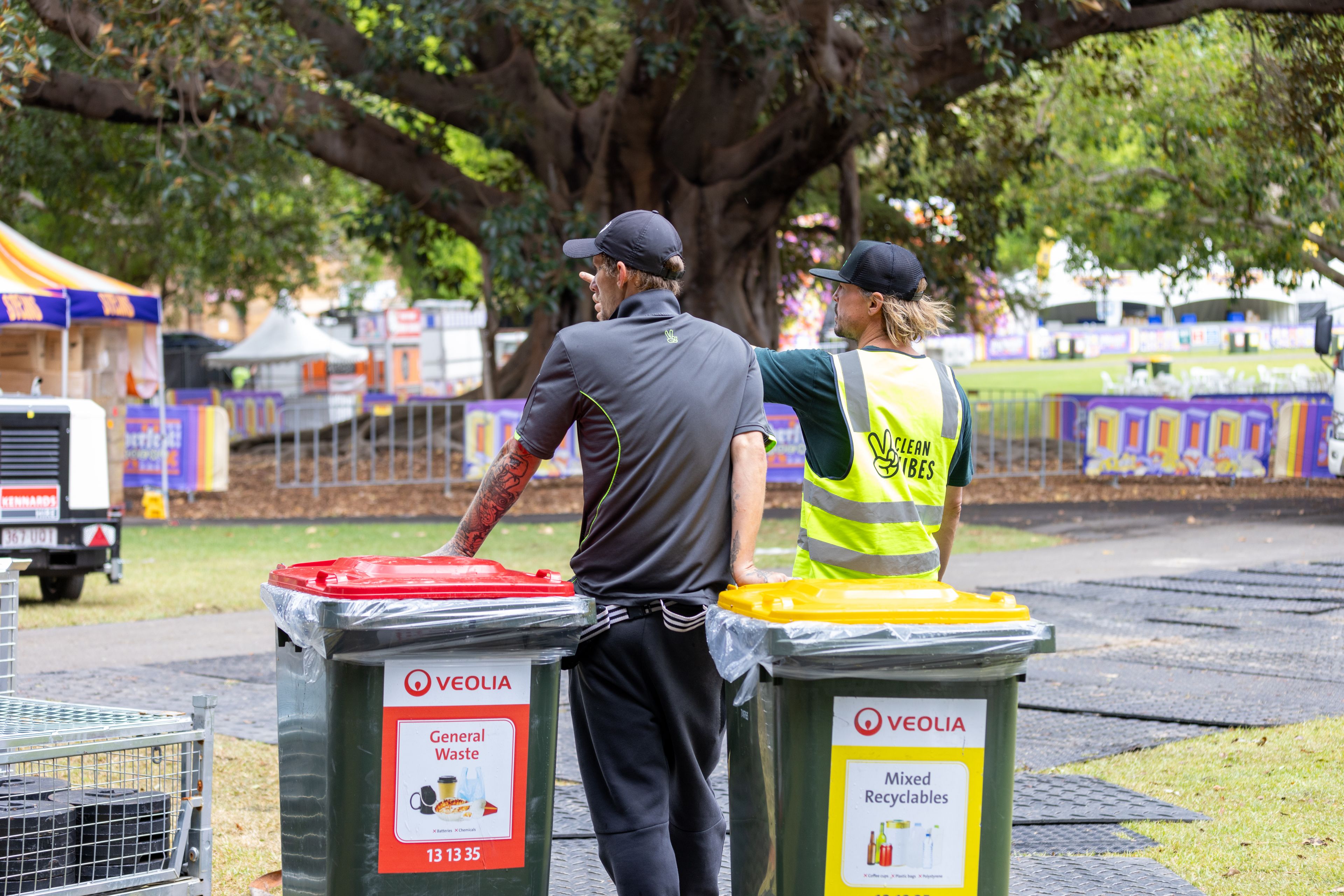 Clean Vibes staffs talking about where to place new set of bins at Oktoberfest Sydney