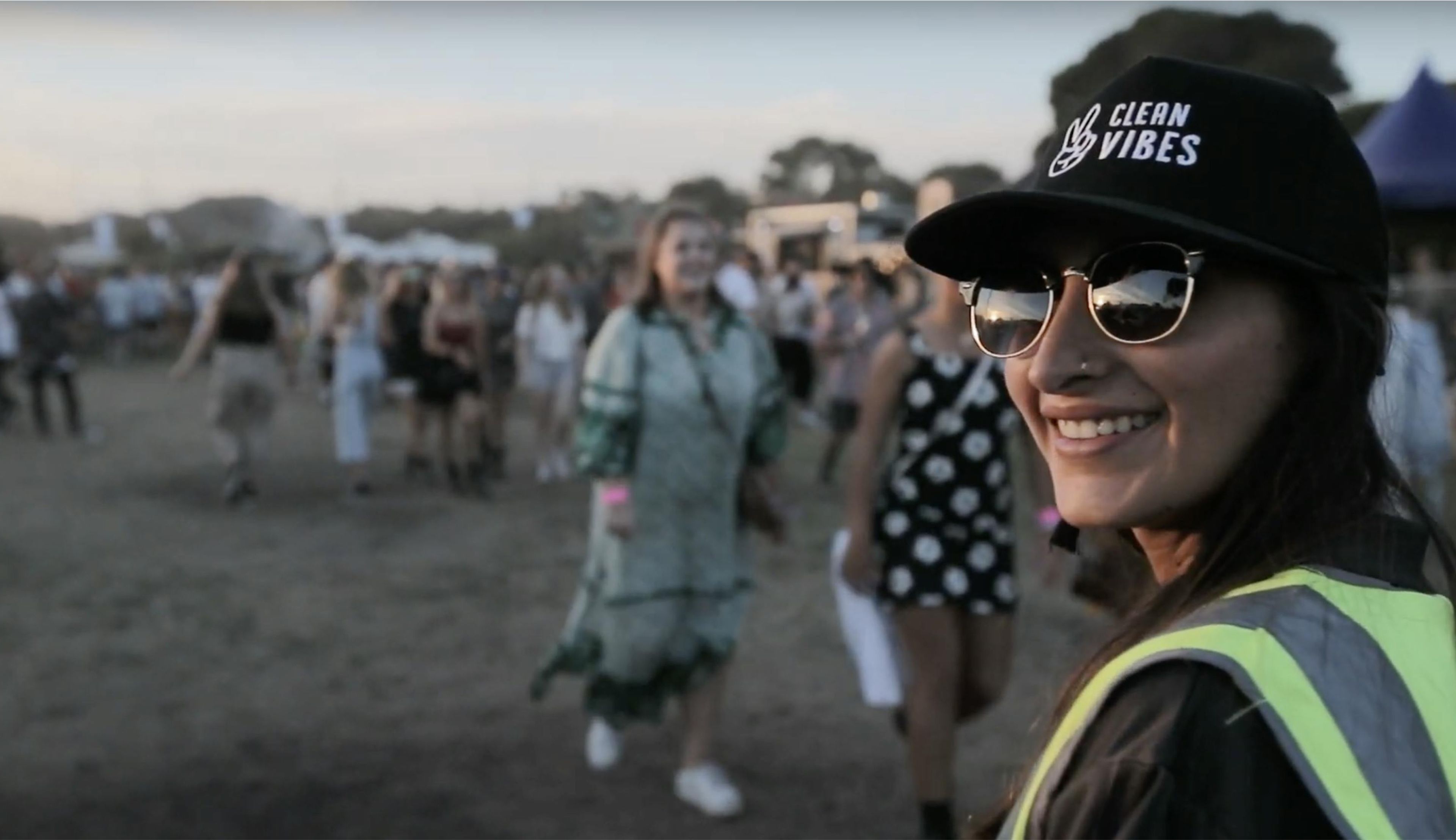 Person smiling while wearing a Clean Vibes hat