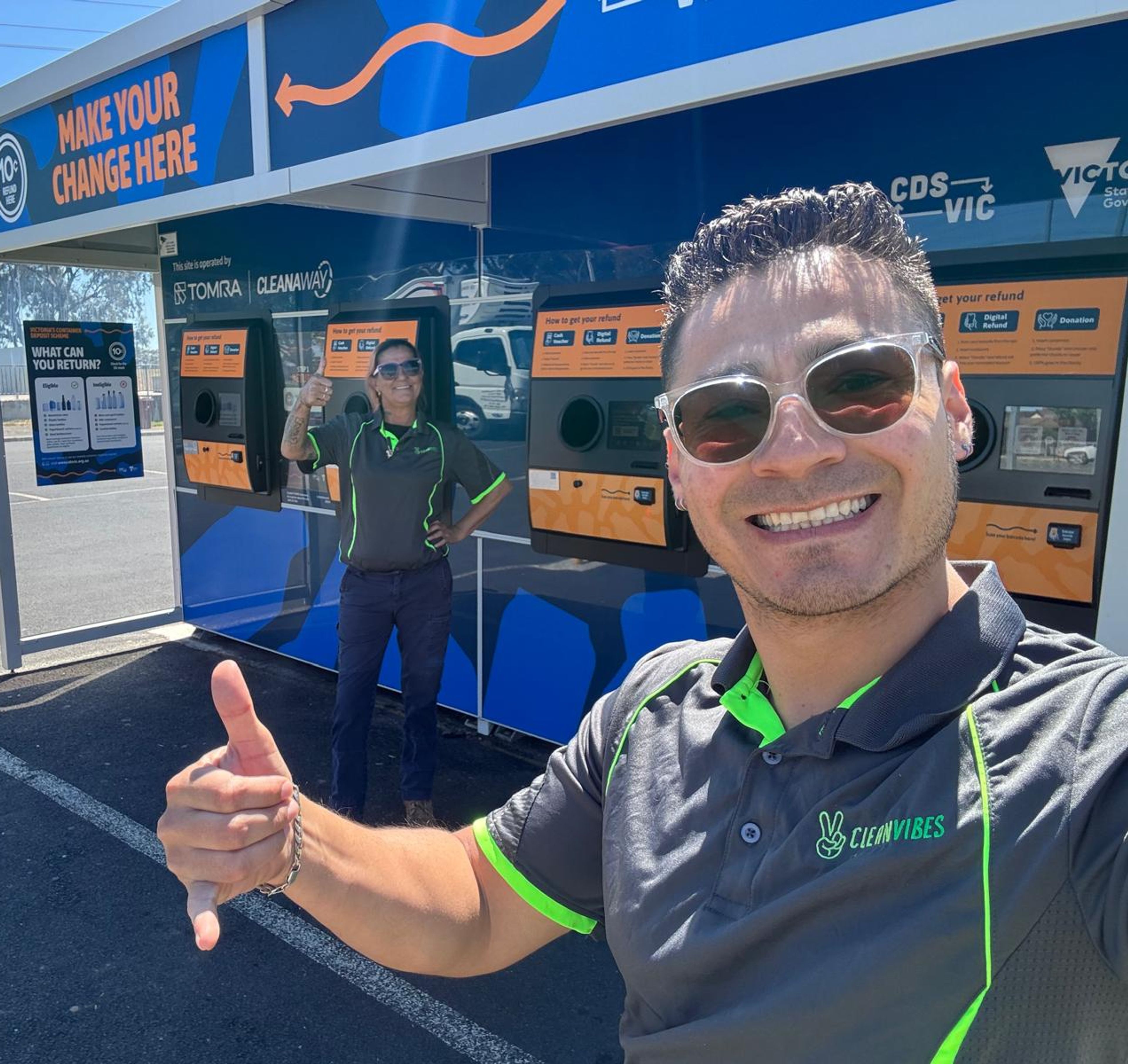 Clean Vibes happy cleaners in front of RVM machines