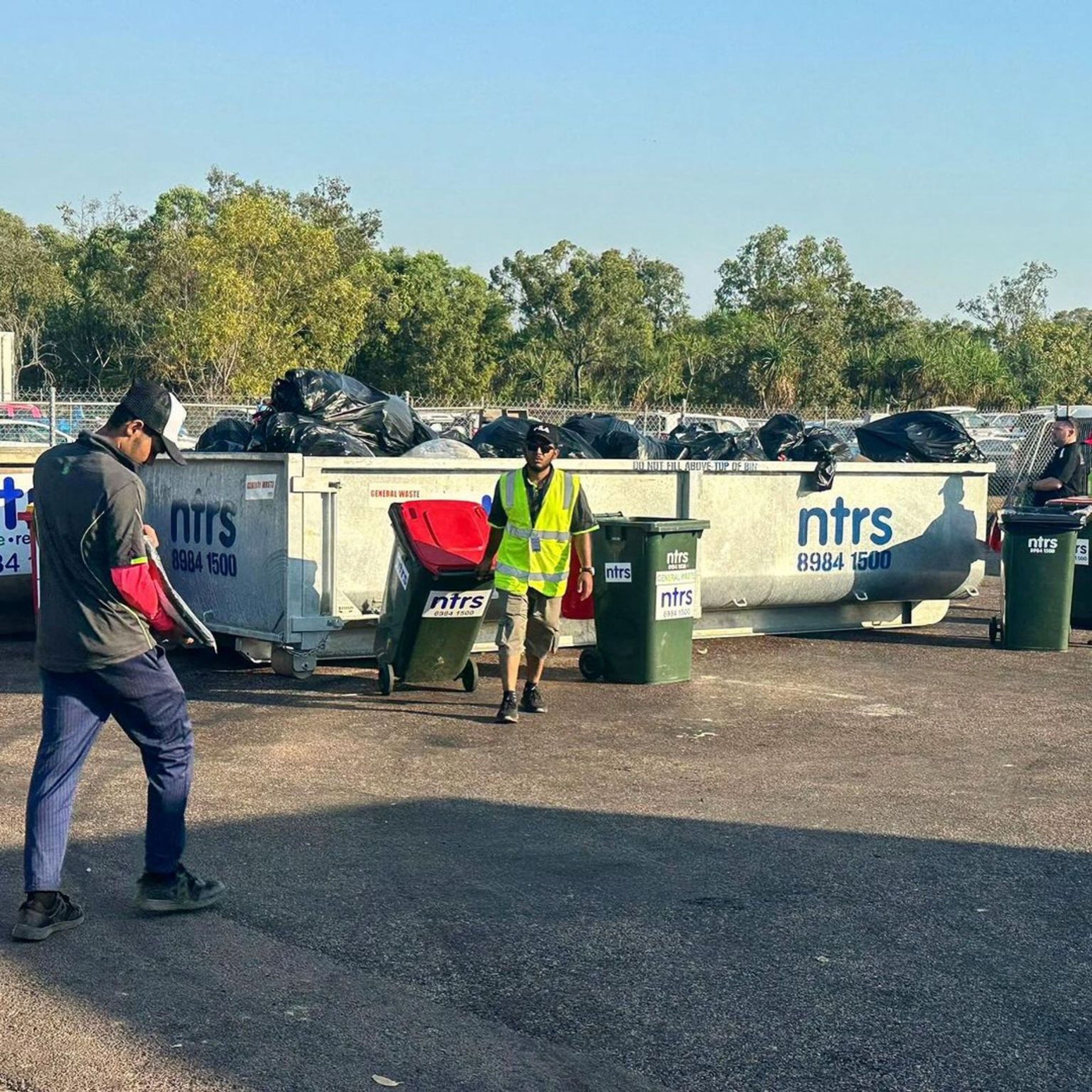 Clean Vibes staff bringing empty bin back at the event