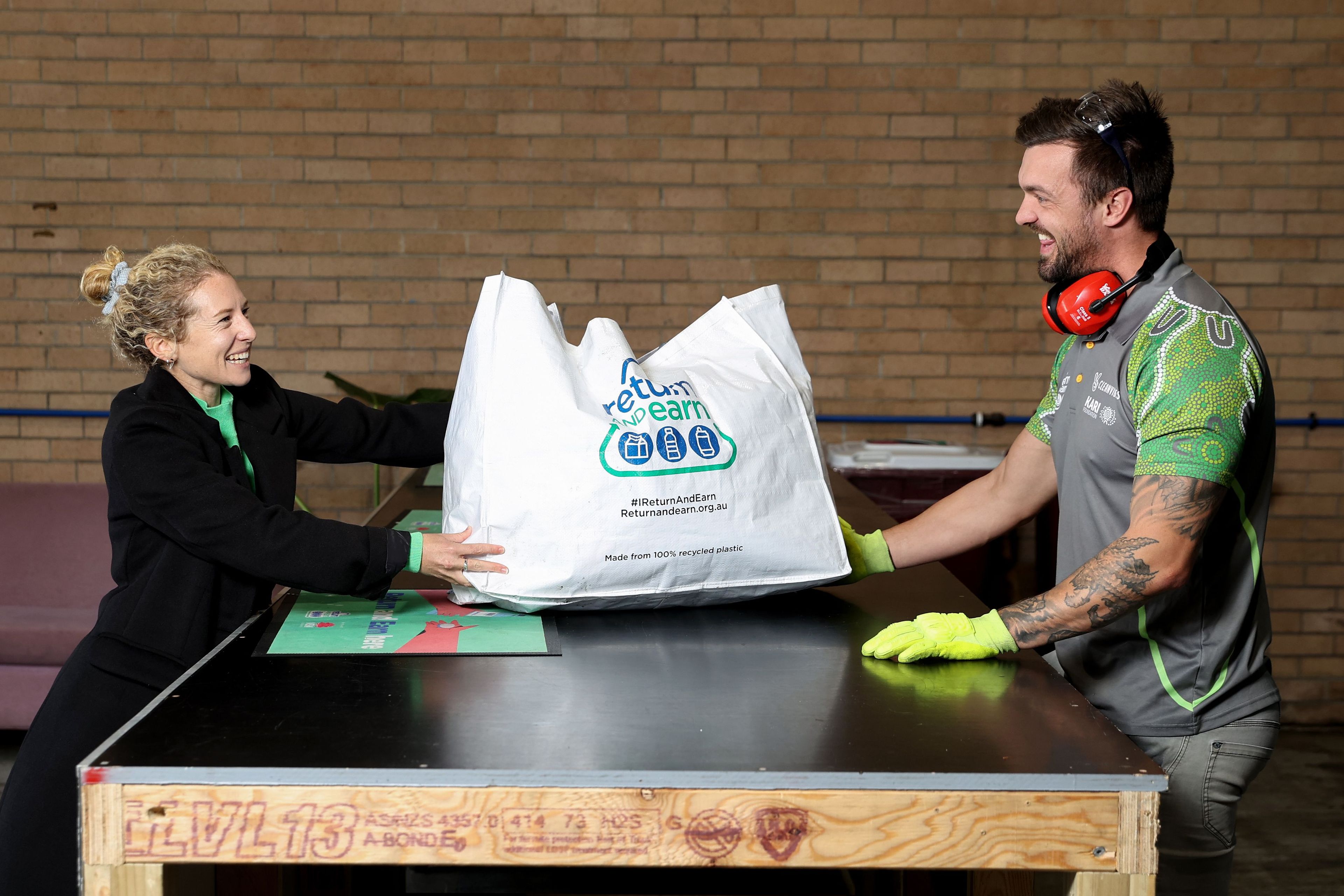 Customer bringing bag with eligible containers to City Return and Earn depot 