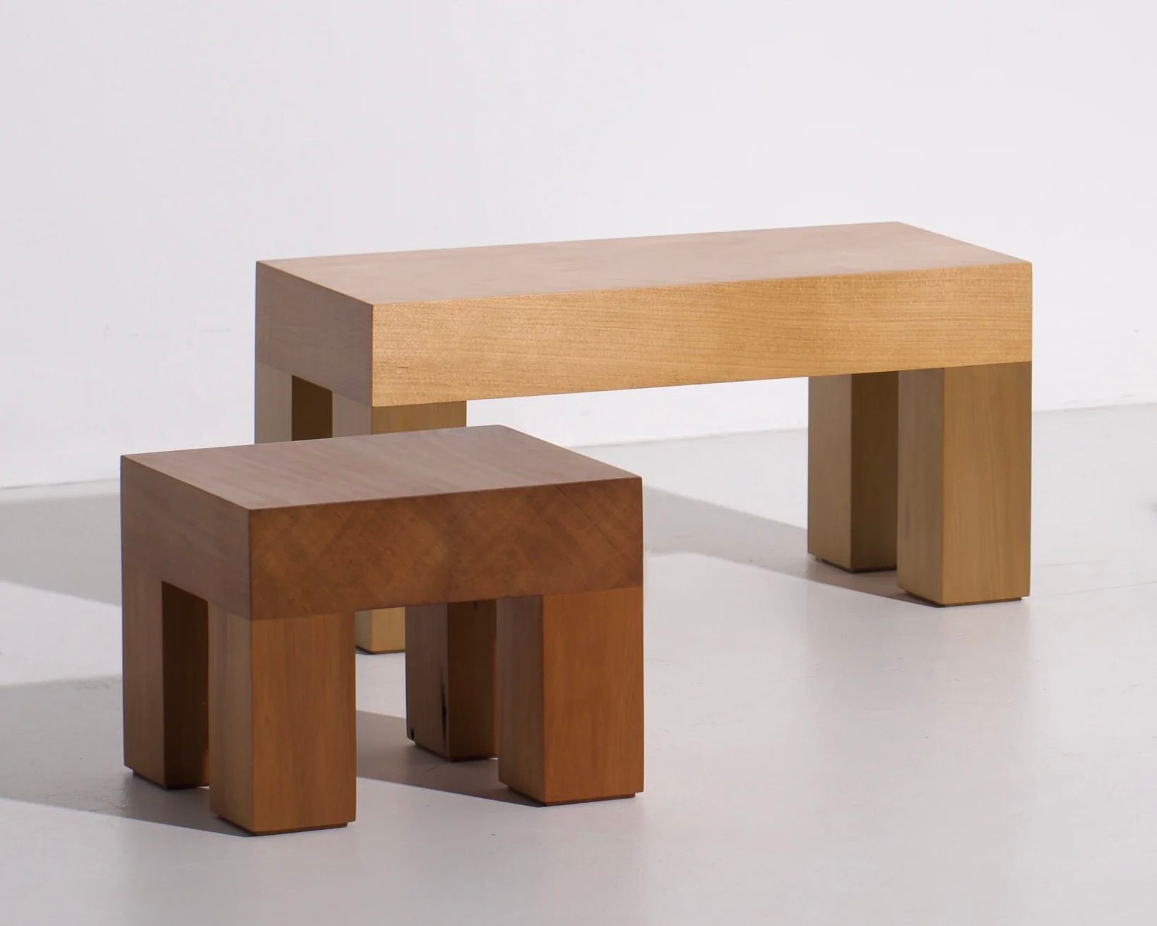 A collection of Courtney Petleys square low stools hand made from local New Zealand timbers.
